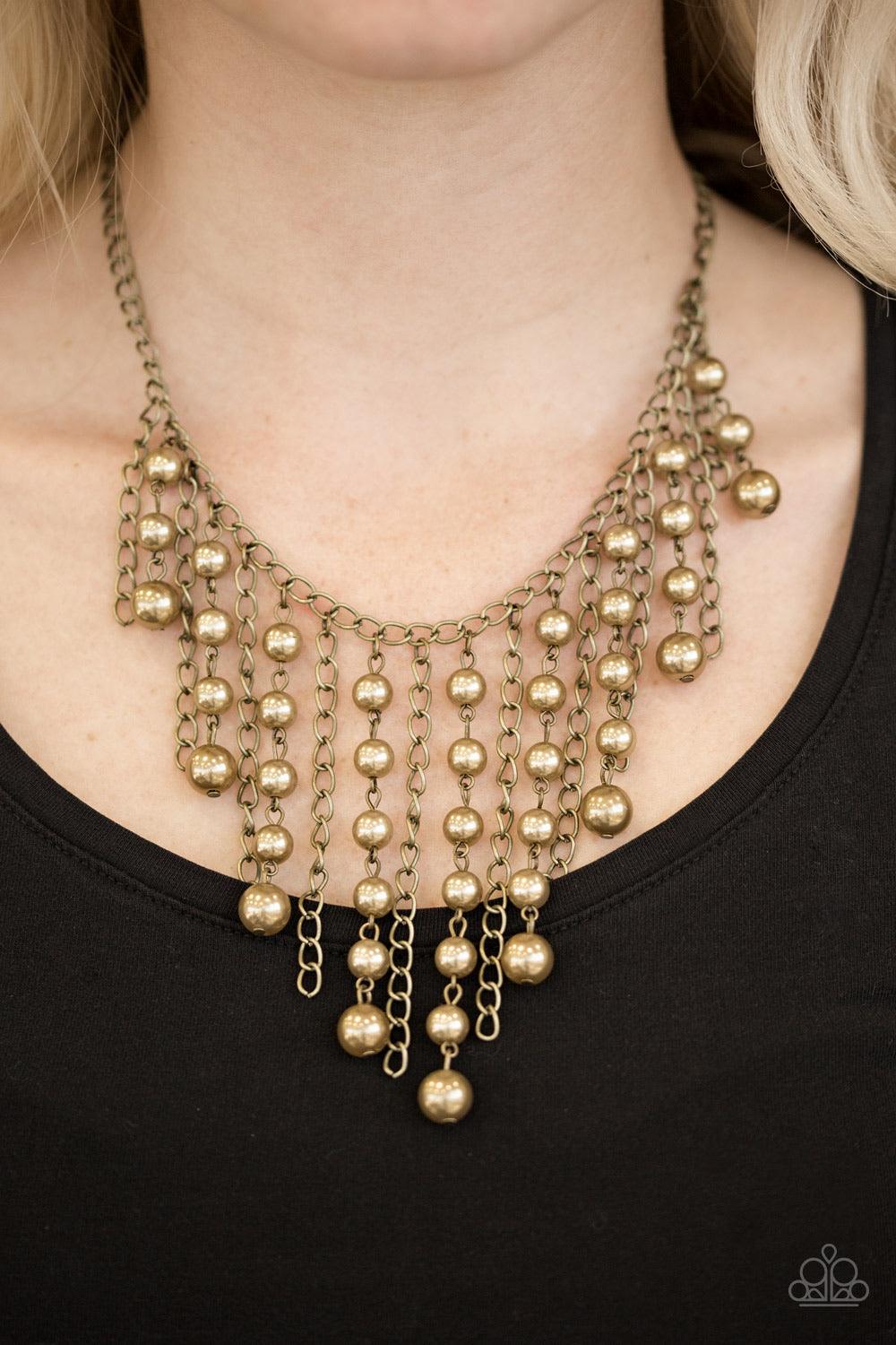 Paparazzi Accessories STUN Control - Brass Pearly brass beads trickle along strands of glistening brass chains, creating a tapered fringe below the collar. Features an adjustable clasp closure. Sold as one individual necklace. Includes one pair of matchin