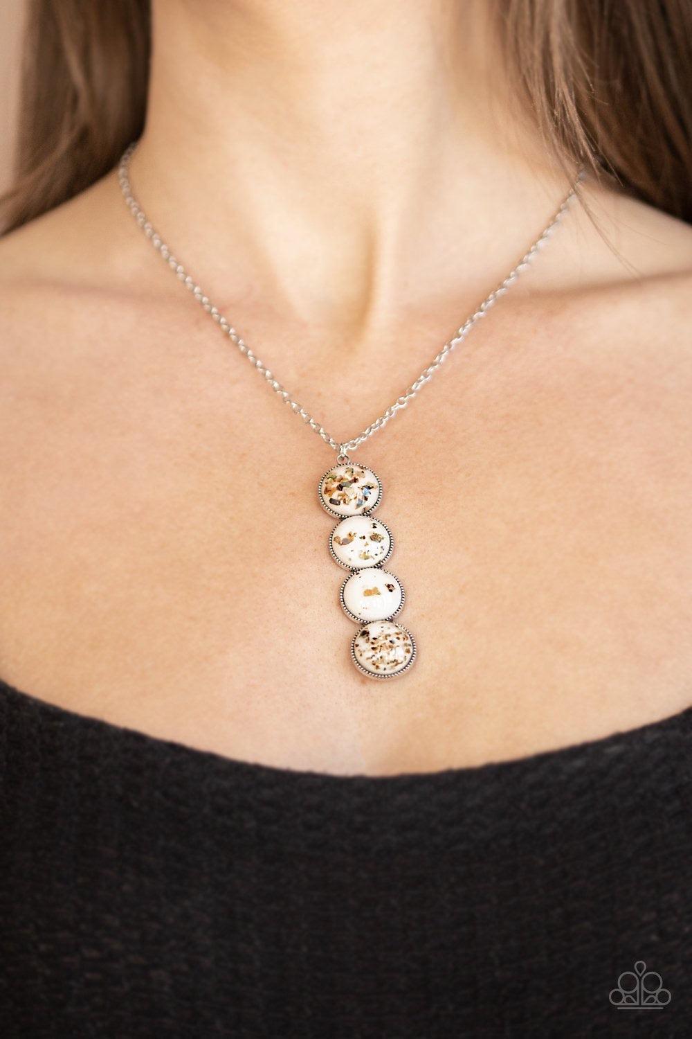 Paparazzi Accessories Confetti and Cocktails - White Featuring flecks of iridescent shell-like accents, four glassy white beads stack into a dazzling pendant at the bottom of a shimmery silver chain for an effervescent look. Features an adjustable clasp c