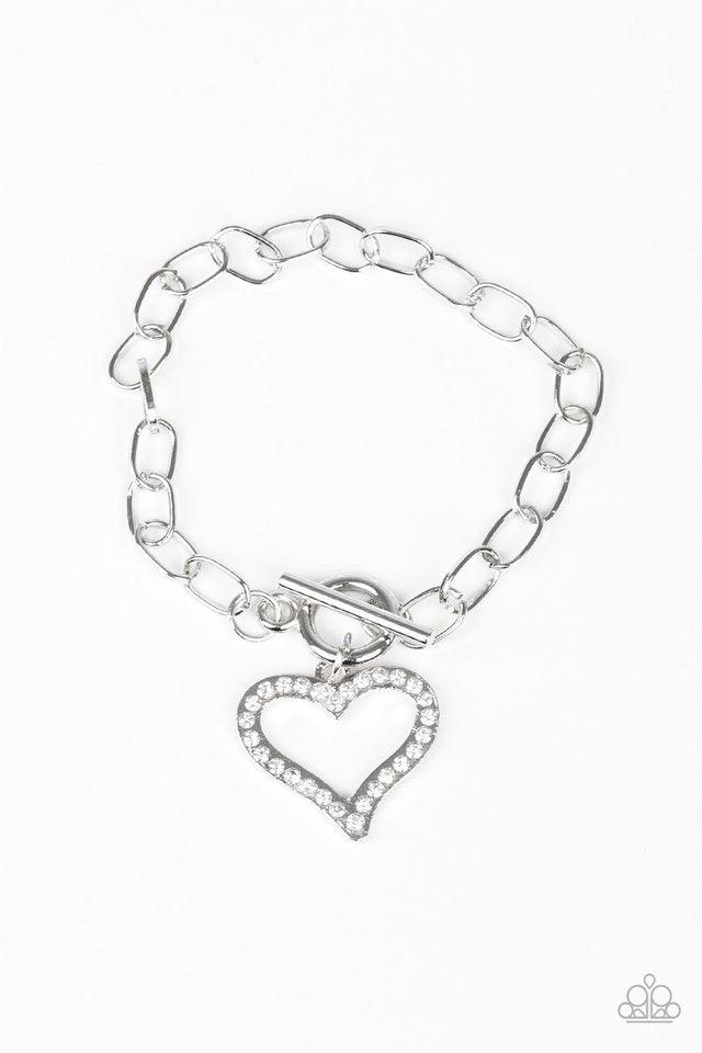 Paparazzi Accessories March to a Different HEARTBEAT - White Encrusted in glassy white rhinestones, a glittery silver heart charm swings from a glistening silver chain for a flirtatious look. Features a toggle closure. Sold as one individual bracelet. Jew