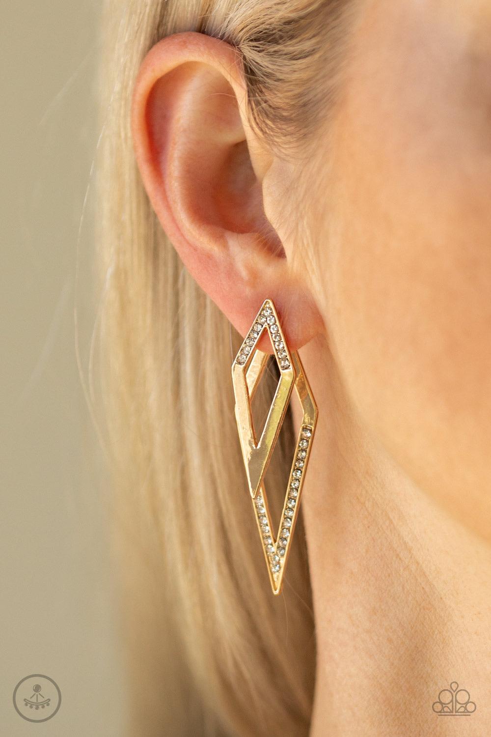 Paparazzi Accessories Point-Bank - Gold Encrusted in sections of glassy white rhinestones, a gold kite-shaped frame attaches to a double-sided post, designed to fasten behind the ear. As if dipped in white rhinestones, a larger gold kite-shape peeks out b