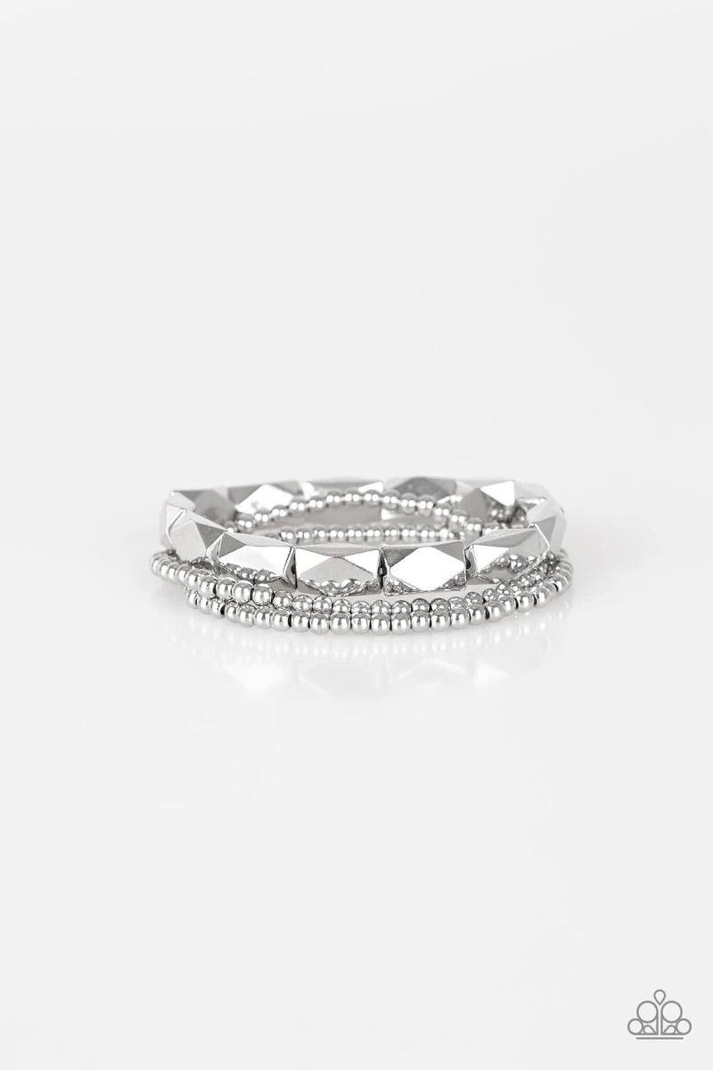 Paparazzi Accessories Metal Movement - Silver Dainty silver beads and faceted silver accents are threaded along stretchy bands and stacked across the wrist for a bold industrial look.Sold as one set of three bracelets. Jewelry