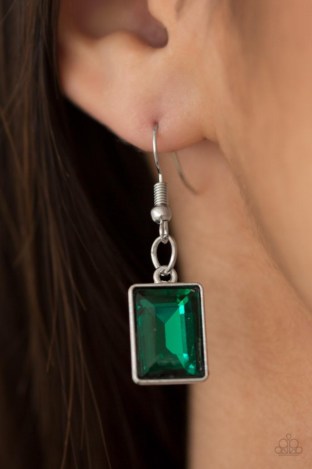 Paparazzi Accessories Wear it Like You Mean It! - Green Featuring a regal emerald-style cut, a glassy green rhinestone is pressed into a sleek silver frame. The glittery frame swings from the bottom of a bold silver chain, creating a glamorous pendant bel