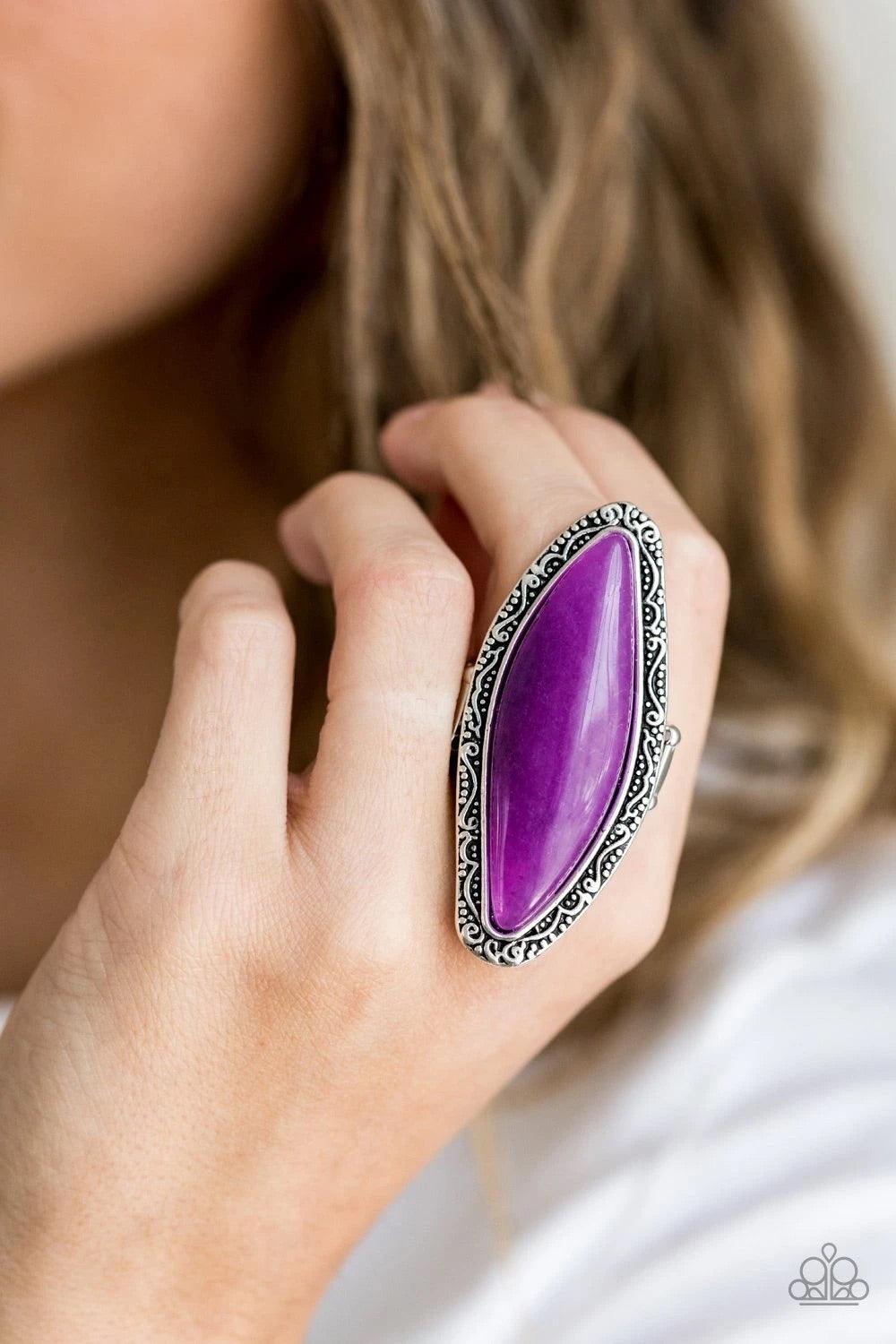 Paparazzi Accessories Mineral Mine - Purple An oblong sparkling purple stone is pressed into a shimmery silver frame embossed and studded in tactile filigree, creating a dramatic stone display atop the finger. Features a stretchy band for a flexible fit.S
