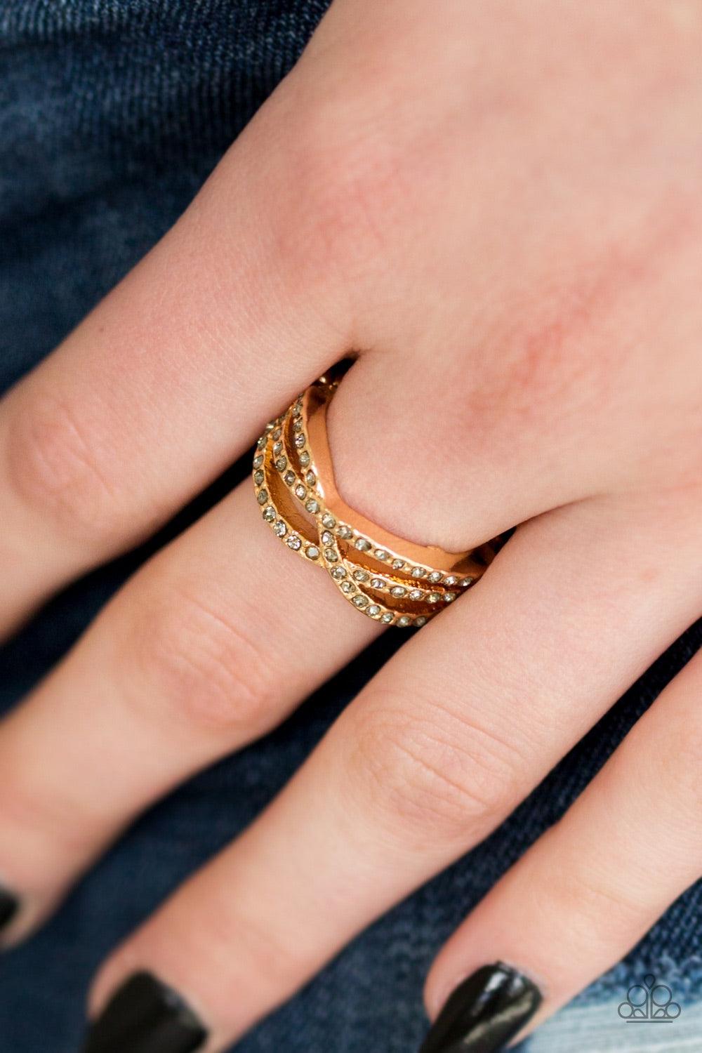Paparazzi Accessories CACHE Advance - Gold Encrusted in glittery smoky rhinestones, shimmery ribbons of gold crisscross across the finger in a timeless fashion. Features a dainty stretchy band for a flexible fit. Jewelry