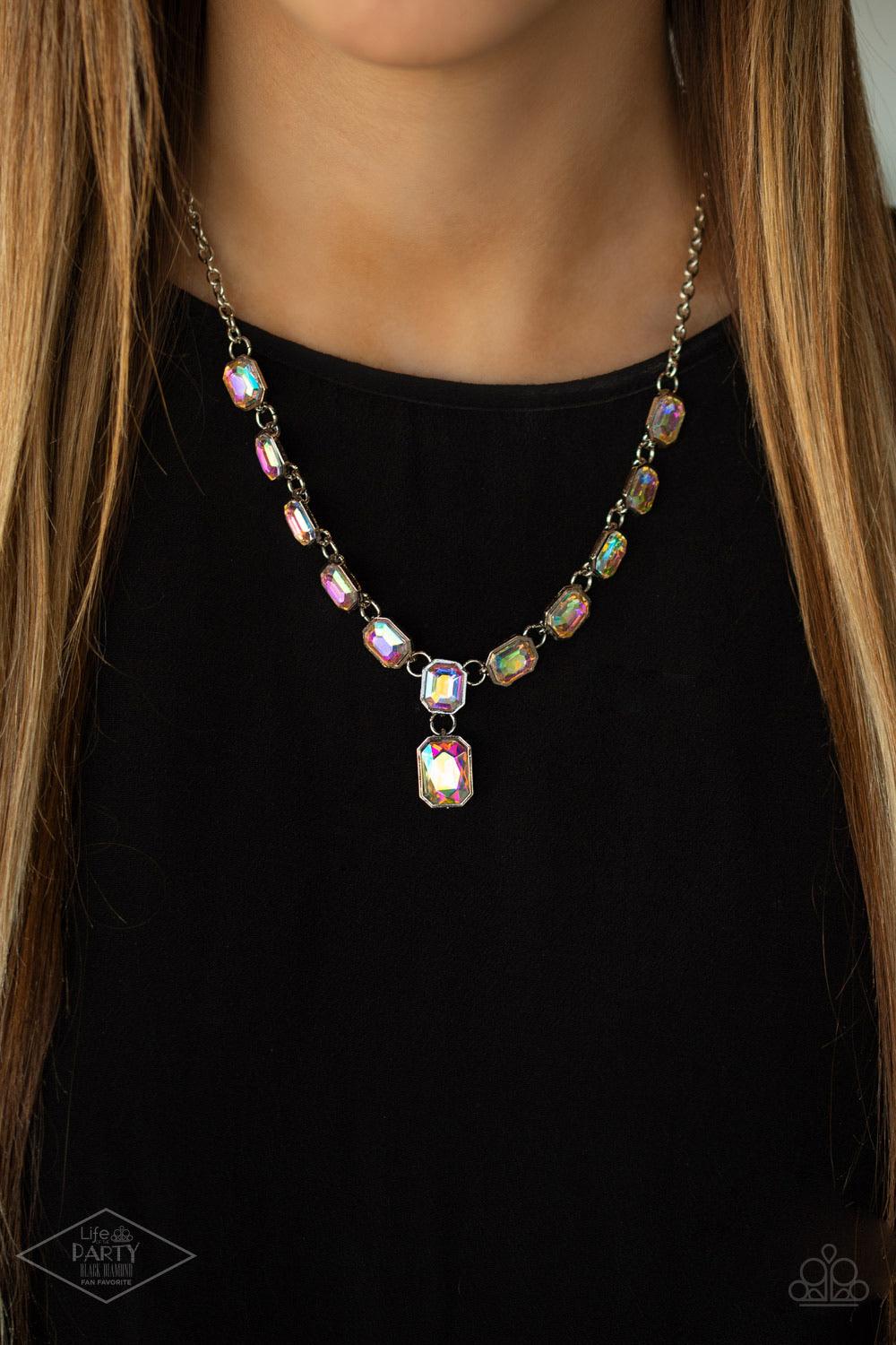 Paparazzi Accessories The Right To Remain - Multi Featuring regal emerald style cuts, glittery iridescent gems link below the collar in an undeniably sparkly fashion. A slightly larger iridescent gem swings from the center, creating an eye-catching pendan