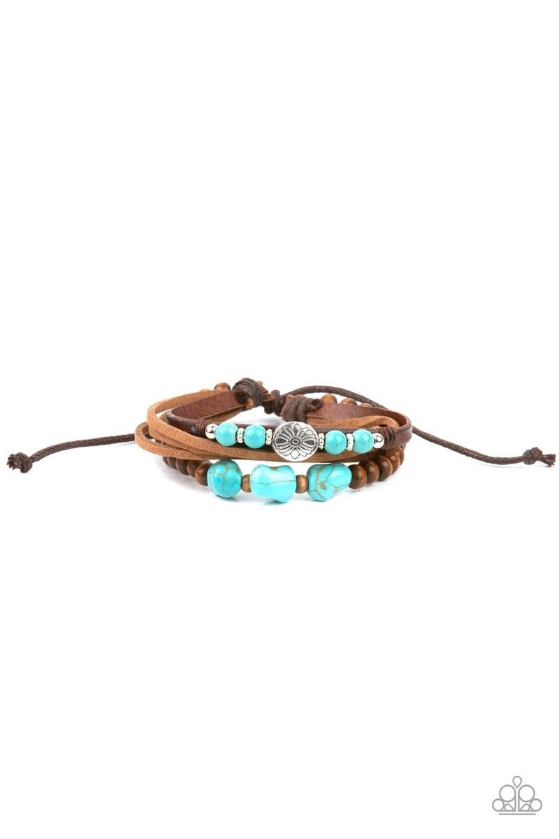 Paparazzi Accessories Act Natural - Blue Featuring natural turquoise stones and silver accents, a collection of leather strands and wooden beads encircle the wrist in a subtle Southwestern fashion. Features an adjustable sliding knot closure. Sold as one