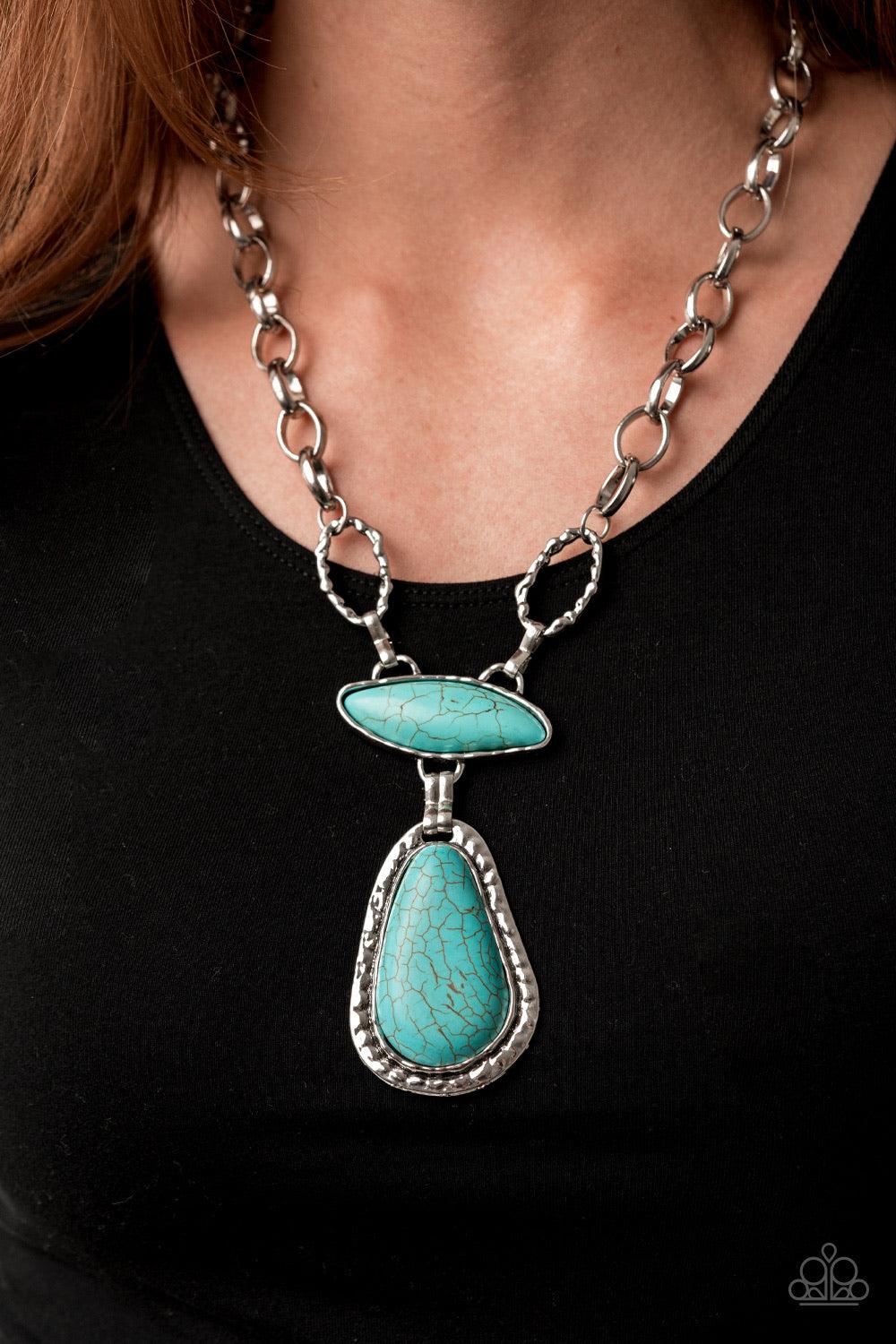 Paparazzi Accessories Rural Rapture - Blue Linked by handcrafted fittings, a pair of imperfect turquoise stones are pressed into asymmetrical hammered silver frames as they stack below the collar. Oversized silver links and a pair of hammered links form i