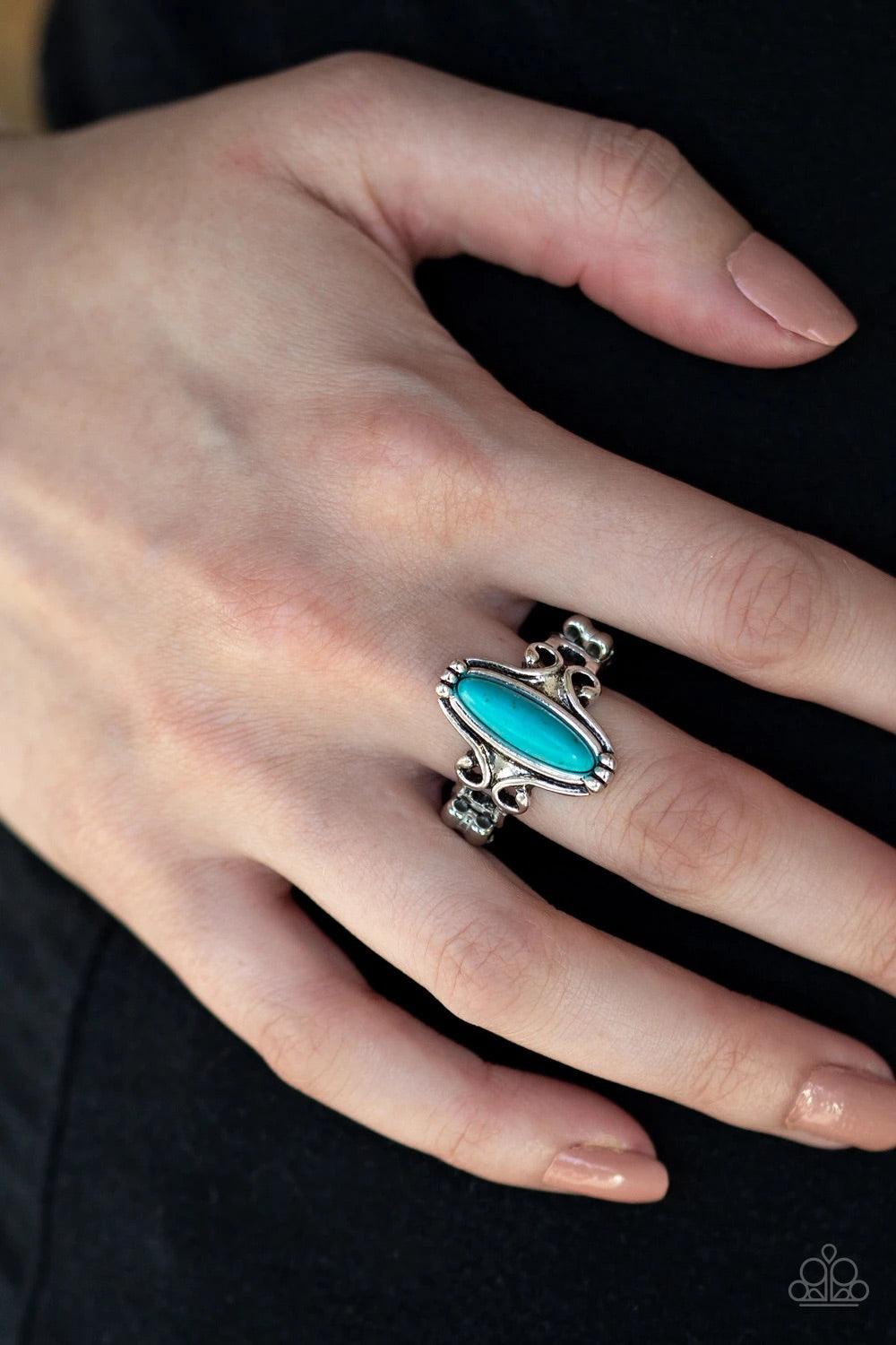 Paparazzi Accessories Desert Canyons - Blue A dainty turquoise stone bead is pressed into the center of an antiqued silver frame radiating with glistening filigree for a seasonal look. Features a dainty stretchy band for a flexible fit. Sold as one indivi
