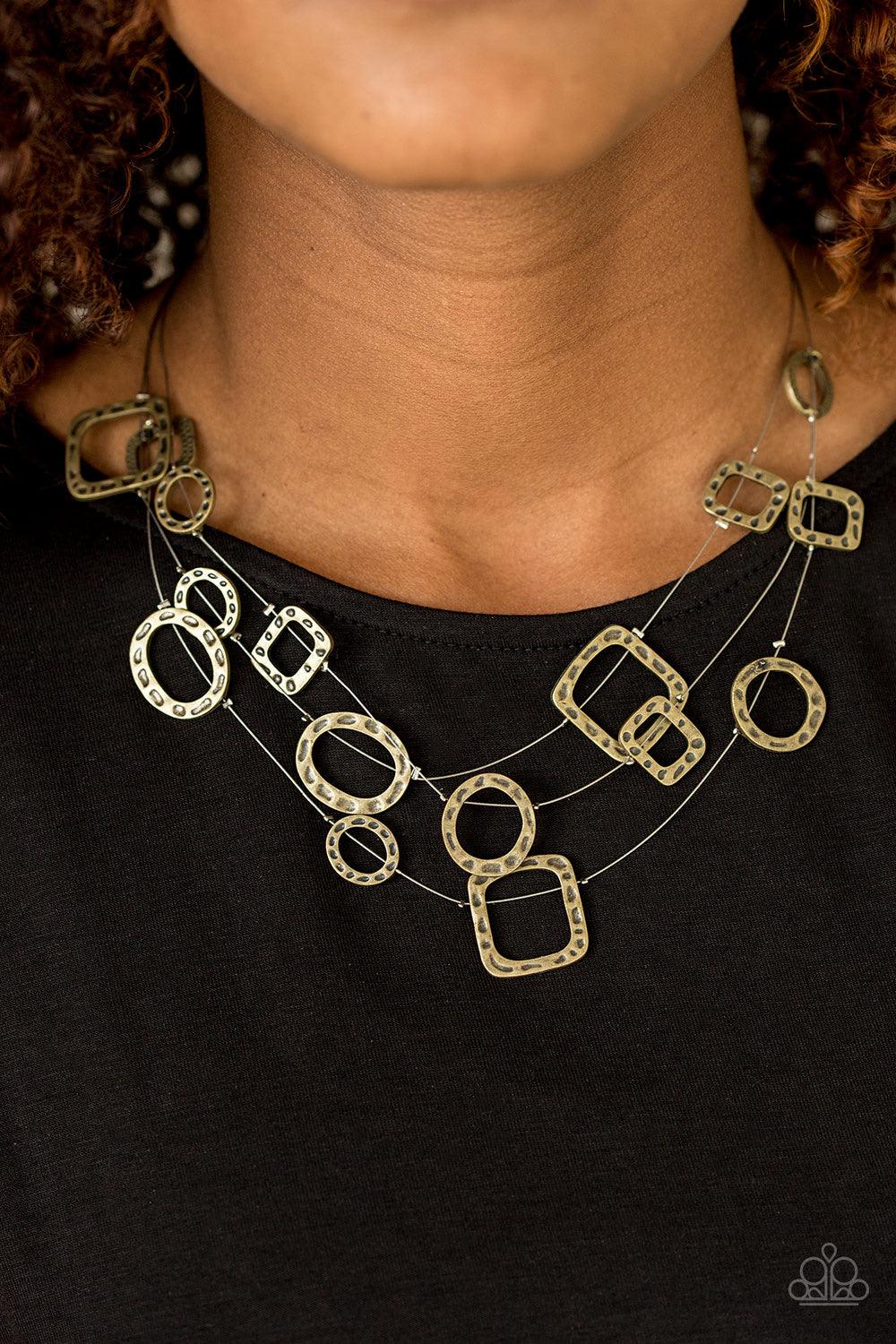Paparazzi Accessories GEO-ing Strong - Brass Delicately hammered in an antiqued shimmer, round and square brass frames are secured in place along three glistening wires. The floating frames drape below the collar in a whimsical fashion. Features an adjust