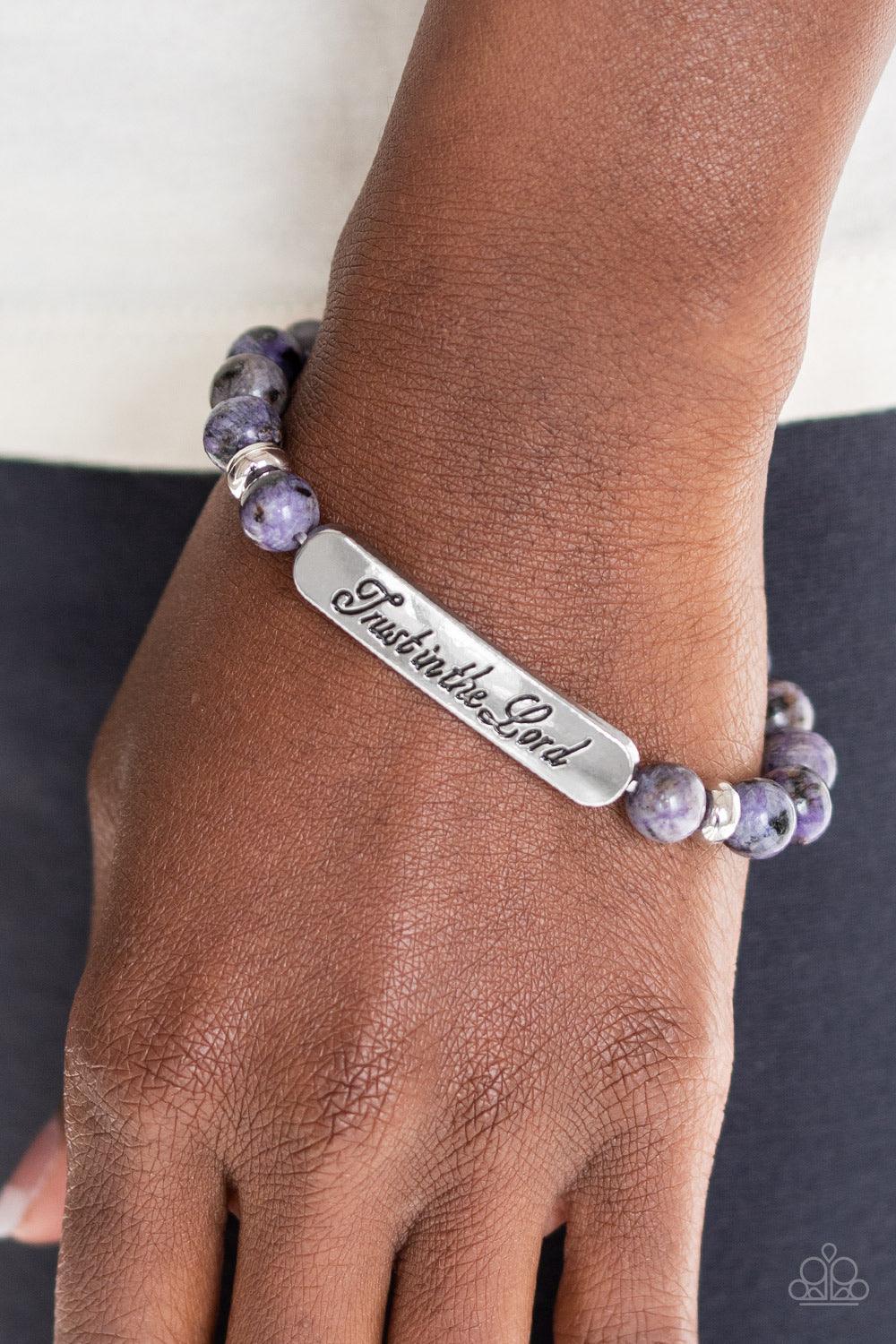Paparazzi Accessories Keep The Trust ~Purple Infused with dainty silver accents, a collection of glassy purple stone beads and a shimmery silver frame stamped in the phrase, "Trust in the Lord", are threaded along a stretchy band around the wrist for an i