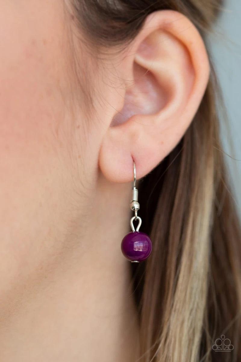 Paparazzi Accessories Count To Zen A- Purple Gradually increasing in size towards the center, dainty purple beads are encrusted along the center of a silver crescent frame. Purple beads flare out from the bottom of the shimmery silver frame, creating a bo