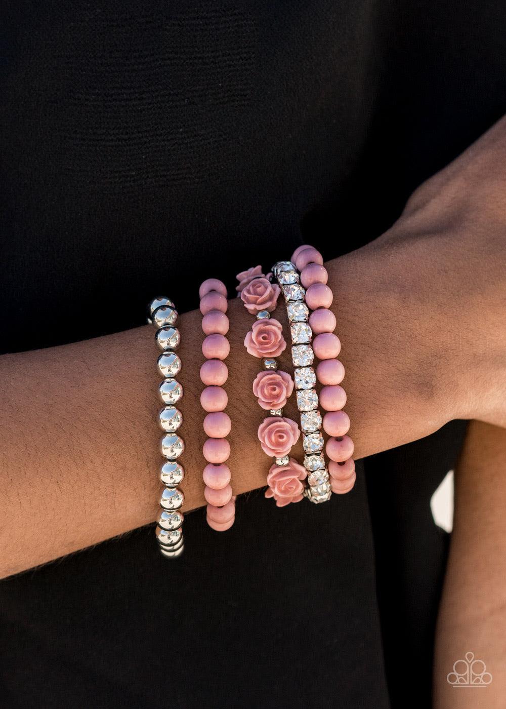 Paparazzi Accessories Rose Garden Grandeur - Pink Featuring a dusky hue, a vintage inspired collection of Rose Tan resin roses and beads joins stretchy bands of silver beaded and glittery white rhinestone dotted bracelets around the wrist for a flawlessly