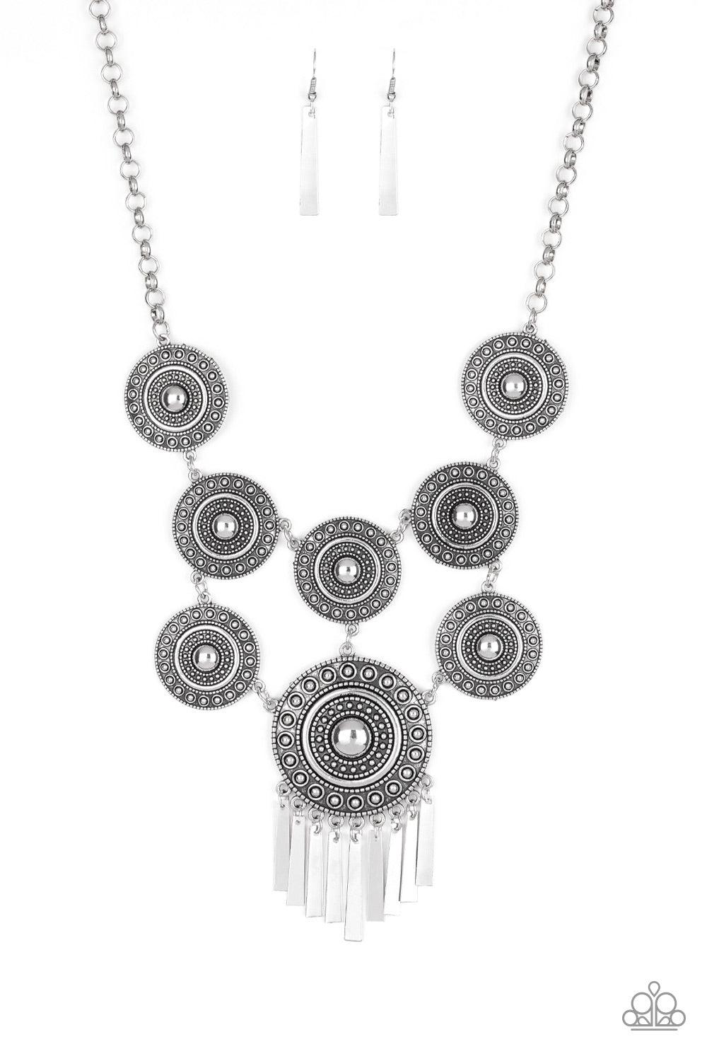 Paparazzi Accessories Modern Medalist - Silver Studded in tactile circular patterns, a collection of antiqued silver disc-like frames connects into a stacked tribal pendant. A larger silver disc is suspended from the bottom, giving way to a fringe of flar