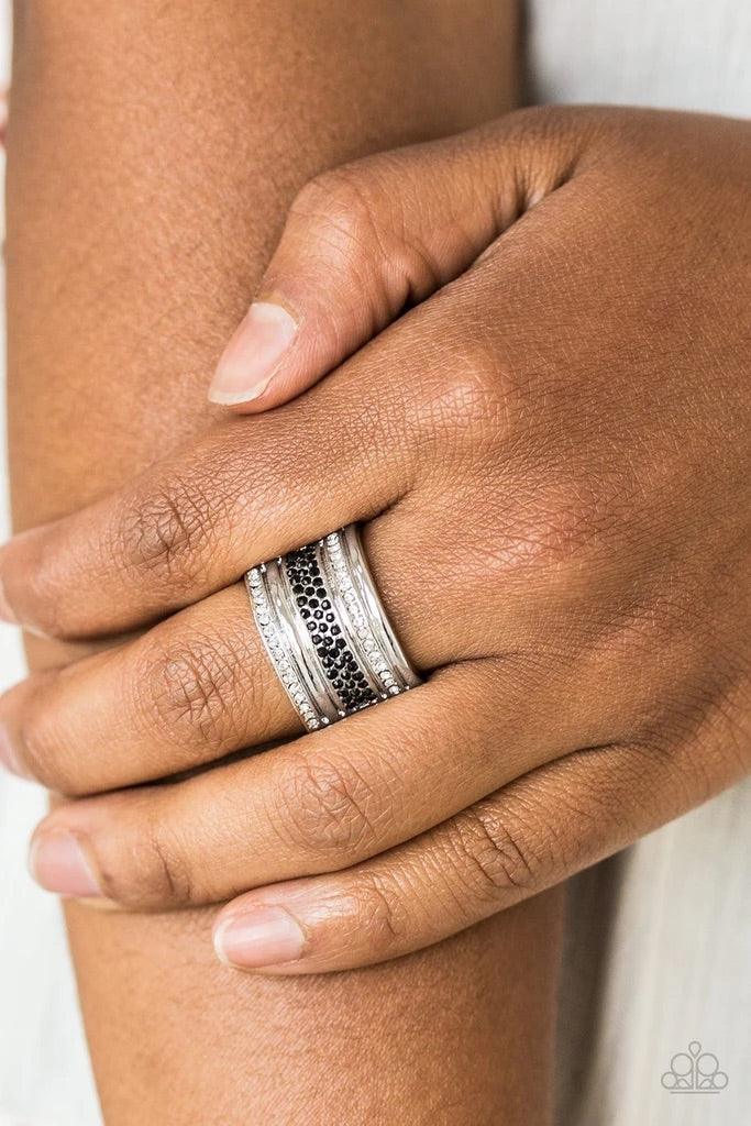 Paparazzi Accessories Top Dollar Drama - Black Black and white rhinestone encrusted bands stack across the finger for a glamorous look. Features a stretchy band for a flexible fit. Sold as one individual ring. Jewelry