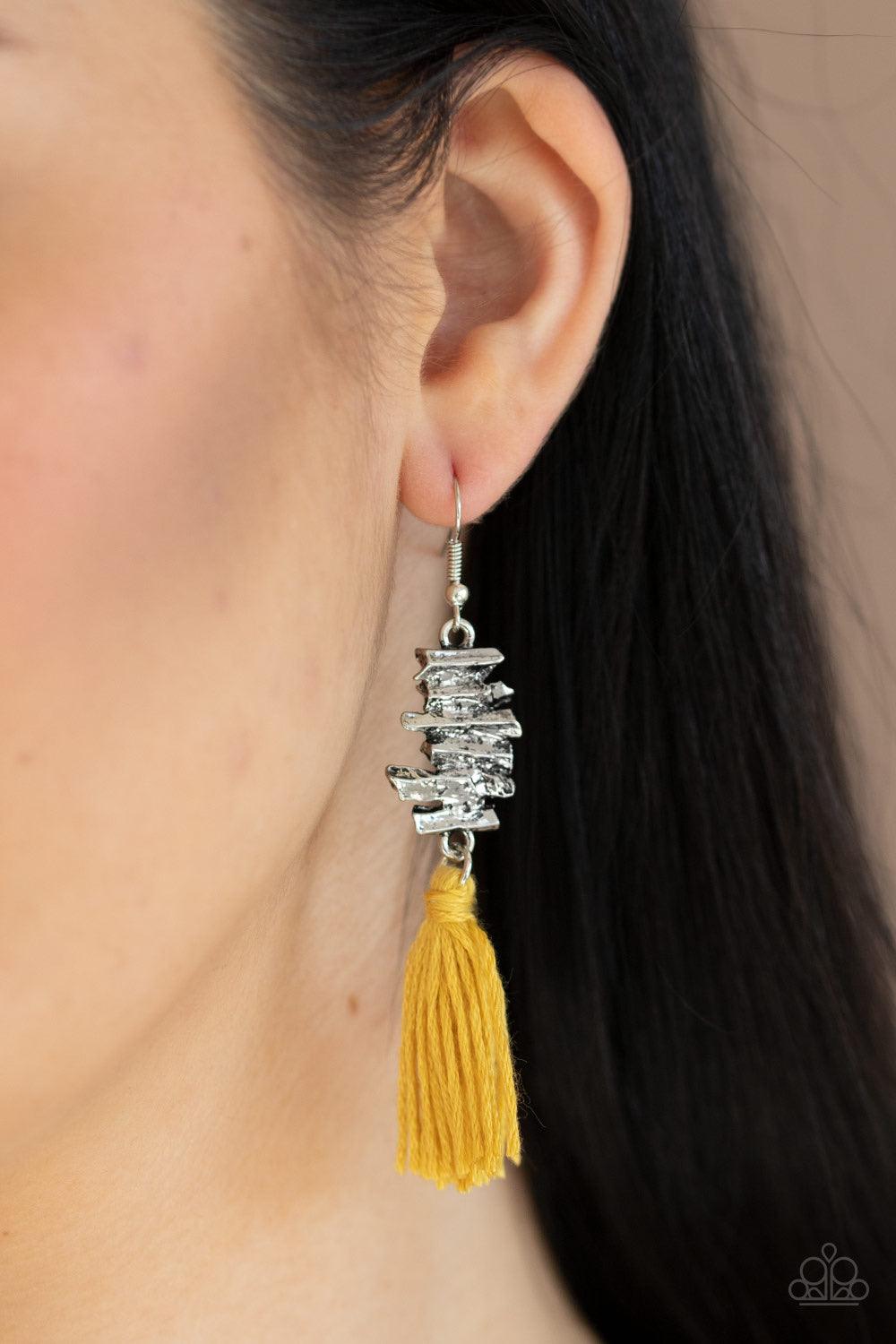 Paparazzi Accessories Tiki Tassel - Yellow A golden yellow threaded tassel swings from the bottom of an abstractly stacked silver frame, creating a colorful fringe. Earring attaches to a standard fishhook fitting. Jewelry