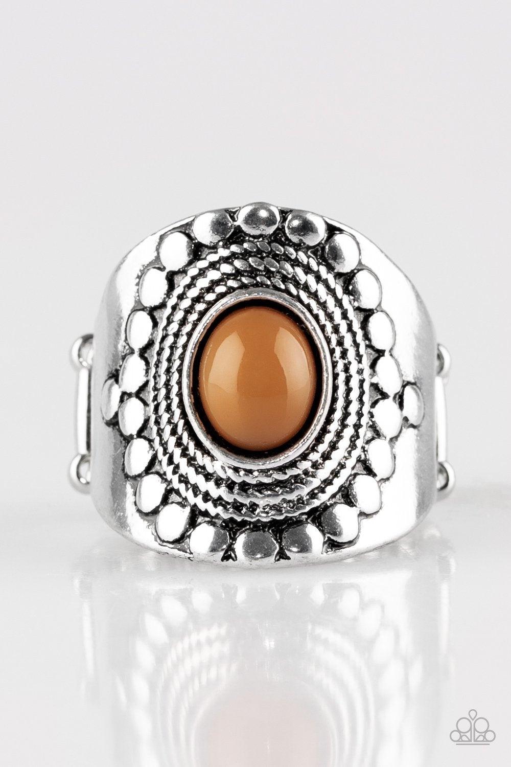 Paparazzi Accessories Zen To One - Brown A shiny Meerkat bead is pressed into the center of a thick band radiating with dotted and rope-like patterns for a seasonal look. Features a stretchy band for a flexible fit. Sold as one individual ring. Jewelry