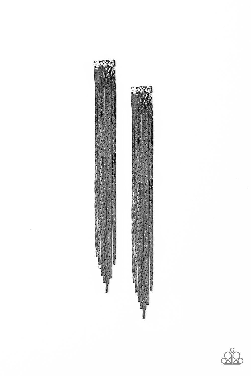 Paparazzi Accessories Night At The Oscar - Black A tassel of flat gunmetal chain cascades from a row of three white rhinestones. Brushed in a high sheen reflective finish, the streaming chains coalesce into a brilliant shimmer. Earring attaches to a stand