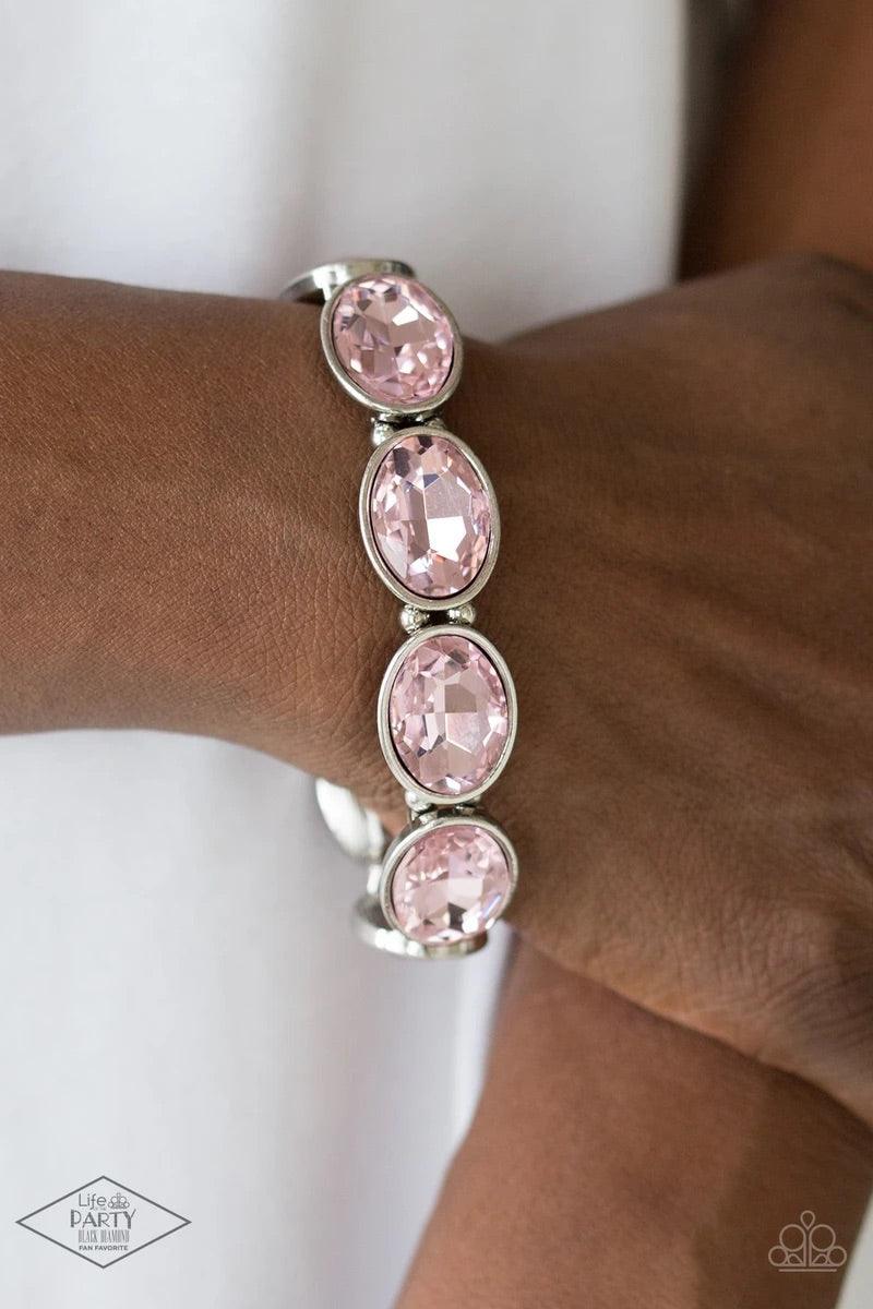 Paparazzi Accessories Diva in Disguise - Pink Glassy pink gems are pressed into sleek silver frames. Infused with dainty silver beads, the glittery frames are threaded along stretchy elastic bands for a glamorous look around the wrist. Sold as one individ