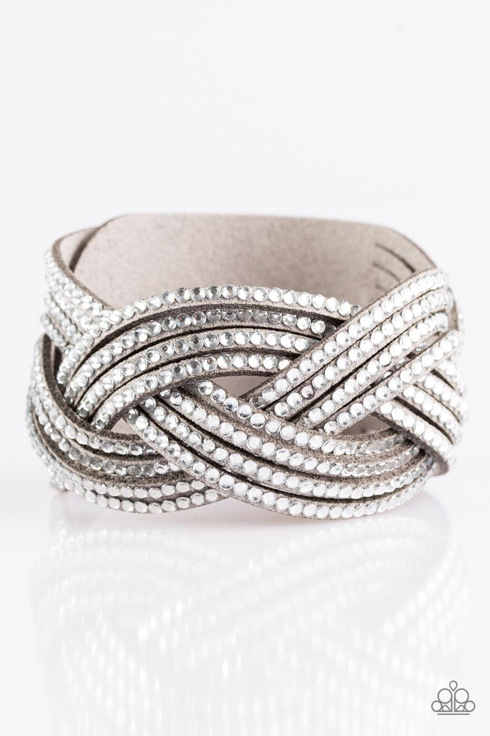 Paparazzi Accessories Big City Shimmer - Silver Glassy white rhinestones are encrusted along crisscrossing strands of gray suede, creating bold shimmer around the wrist. Features an adjustable snap closure. Jewelry