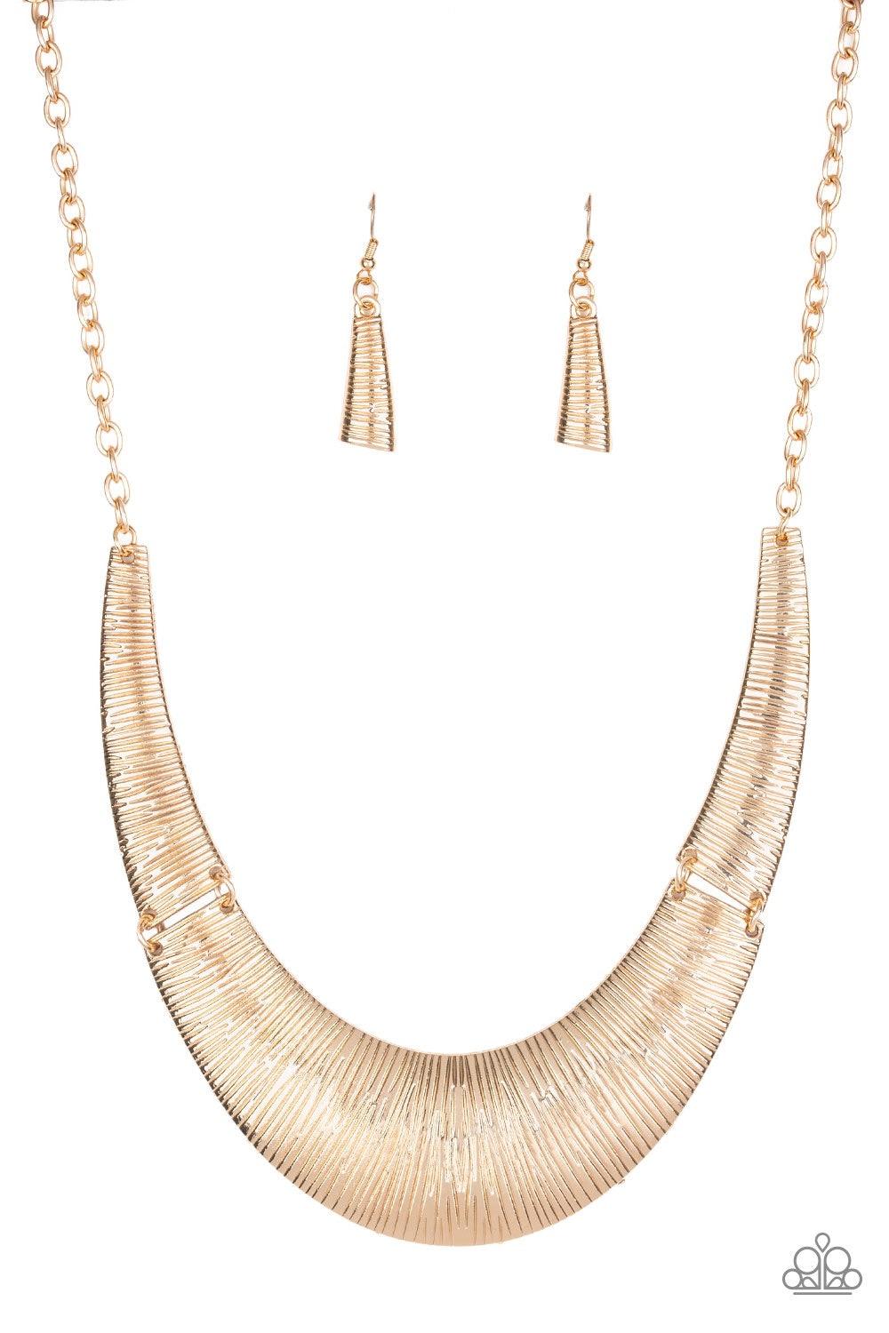 Paparazzi Accessories Feast Or Famine - Gold Etched in linear patterns, dramatic gold plates connect below the collar, joining into a fierce crescent-shaped pendant for a statement making look. Features an adjustable clasp closure. Jewelry