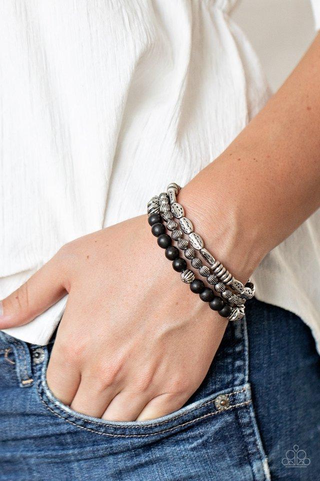 Paparazzi Accessories Trail Mix Mecca - Black An earthy collision of black stones, ornate silver beads and hammered silver accents are threaded along stretchy bands around the wrist, creating colorful layers. Sold as one set of three bracelets. Jewelry