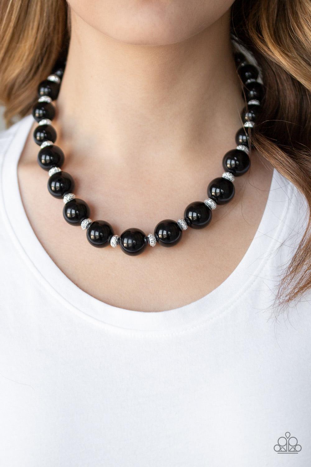 Paparazzi Accessories Uptown Heiress - Black Infused with dainty silvery rhinestone encrusted beads, a refined collection of oversized black beads are threaded along an invisible wire below the collar for a timeless dazzle. Features an adjustable clasp cl