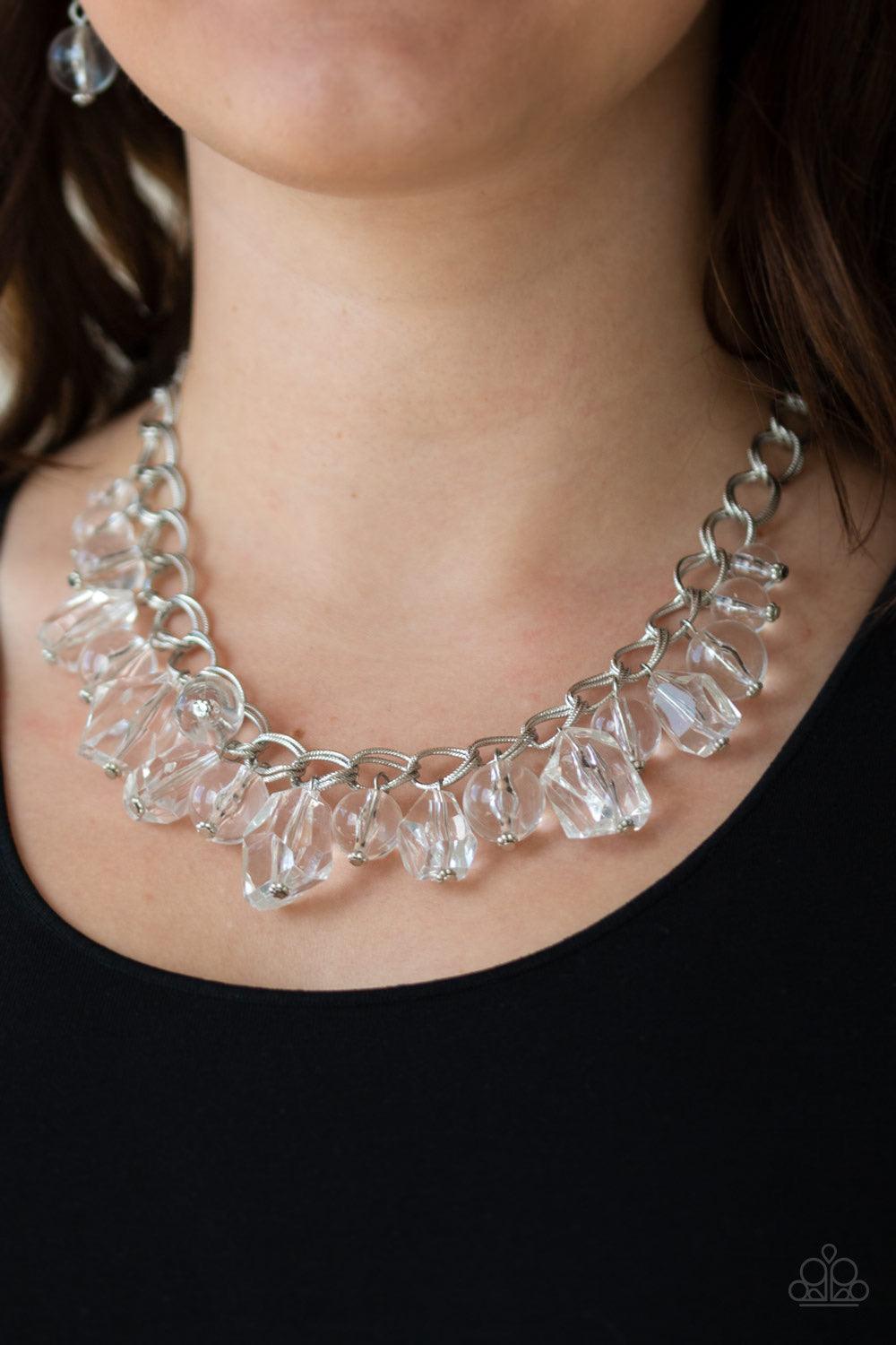 Paparazzi Accessories Gorgeously Globetrotter - White Varying in shape and shimmer, smooth and faceted glassy beads trickle from doubled silver chain links, creating a glamorous fringe below the collar. Features an adjustable clasp closure. Sold as one in