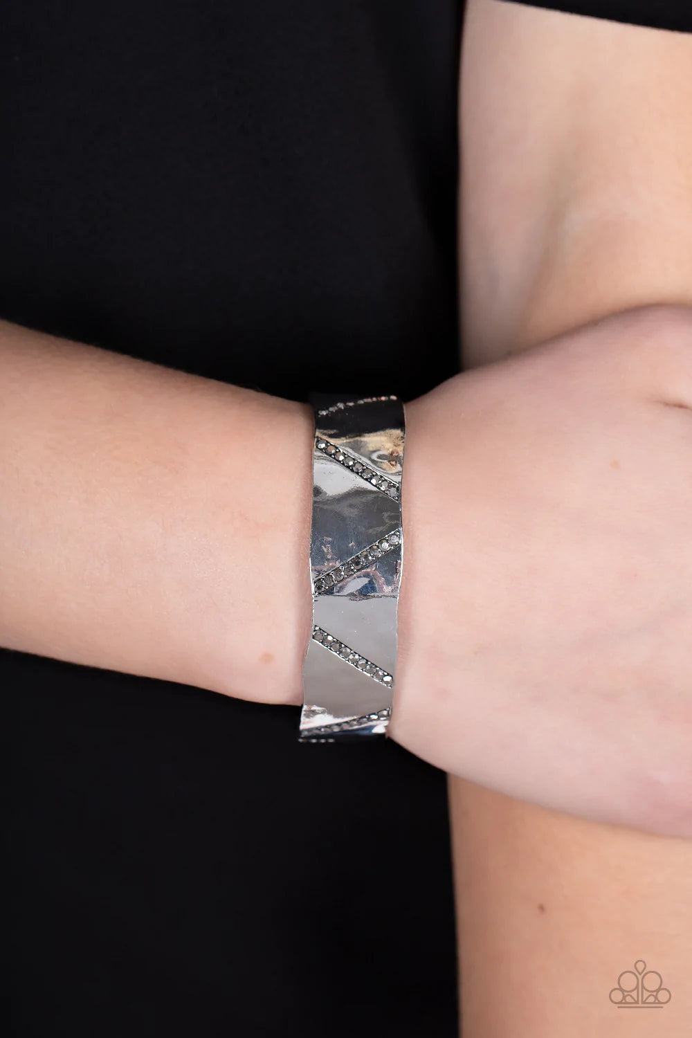 Paparazzi Accessories Couture Crusher - Silver Rows of smoky hematite rhinestones slant across the front of a gently hammered silver cuff that waves around the wrist, result in an edgy shimmer. Sold as one individual bracelet. Jewelry