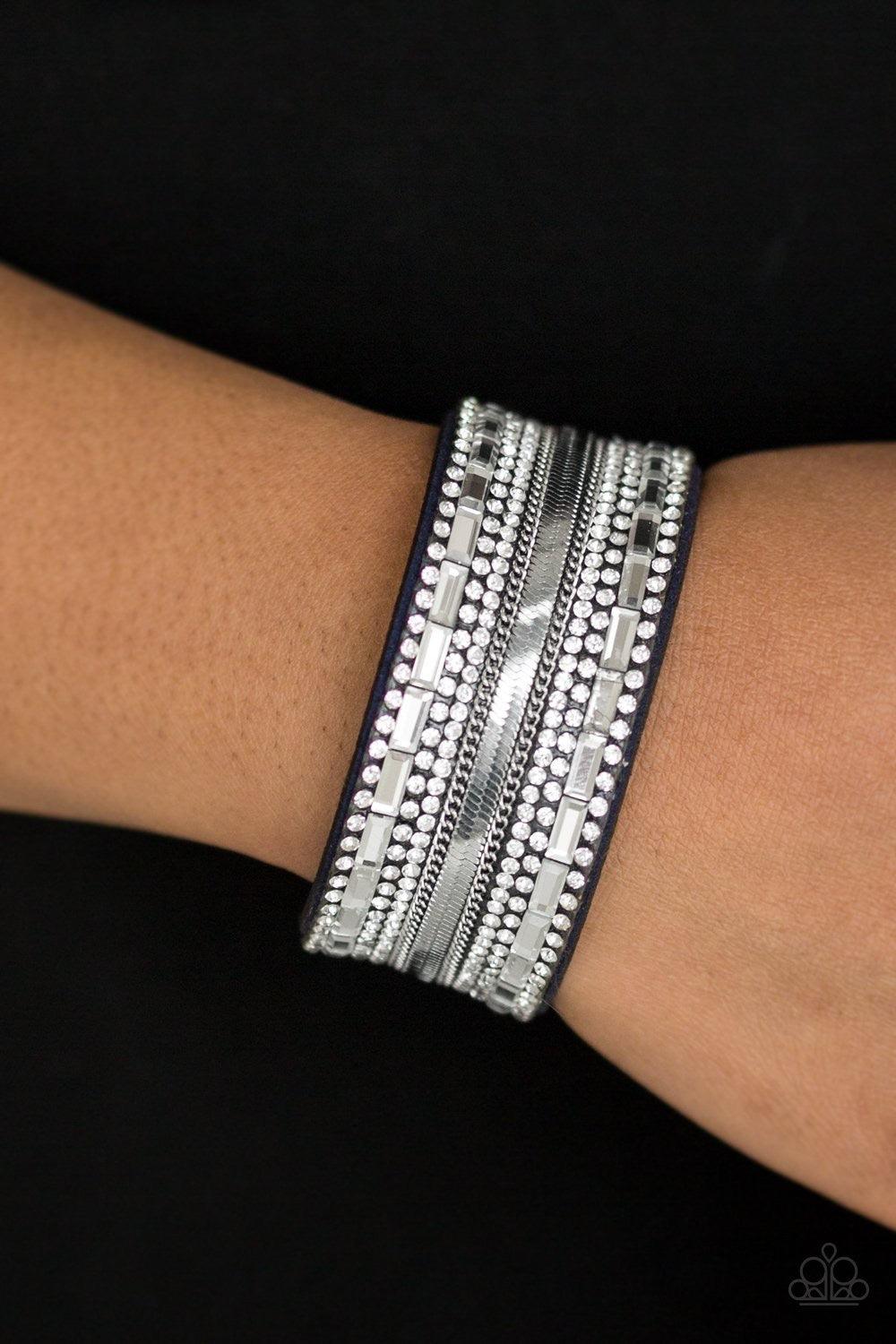 Paparazzi Accessories Teasingly Tomboy - Blue Mismatched silver chains, glassy emerald-cut, and glittery white rhinestones are encrusted along a thick blue suede band for a sassy look. Features an adjustable snap closure. Sold as one individual bracelet.