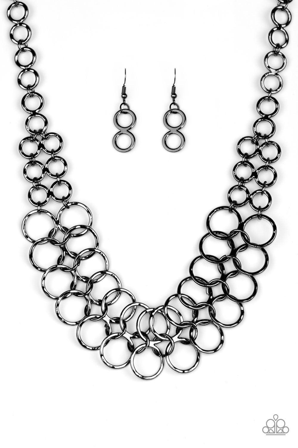 Paparazzi Accessories Metro Maven - Black Gradually increasing in size near the center, double-linked gunmetal rings connect below the collar in a dramatic industrial fashion. Features an adjustable clasp closure. Sold as one individual necklace. Includes