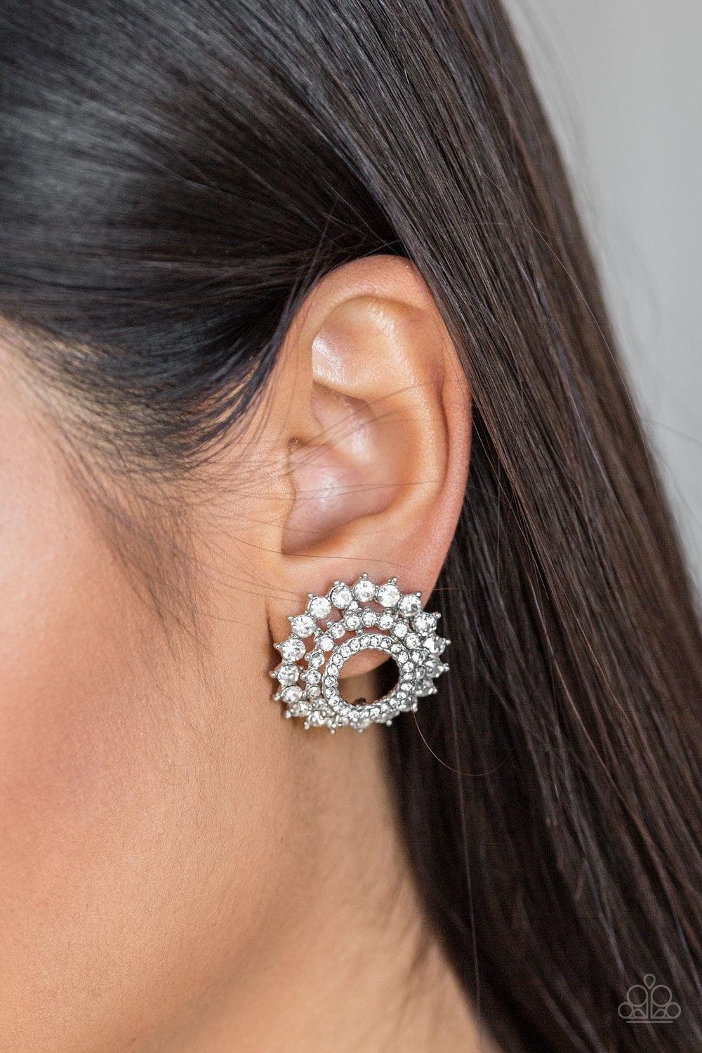 Paparazzi Accessories Buckingham Beauty - White Gradually increasing in size, glassy white rhinestones are encrusted along three stacking silver frames for a regal look. Earring attaches to a standard post fitting. Jewelry