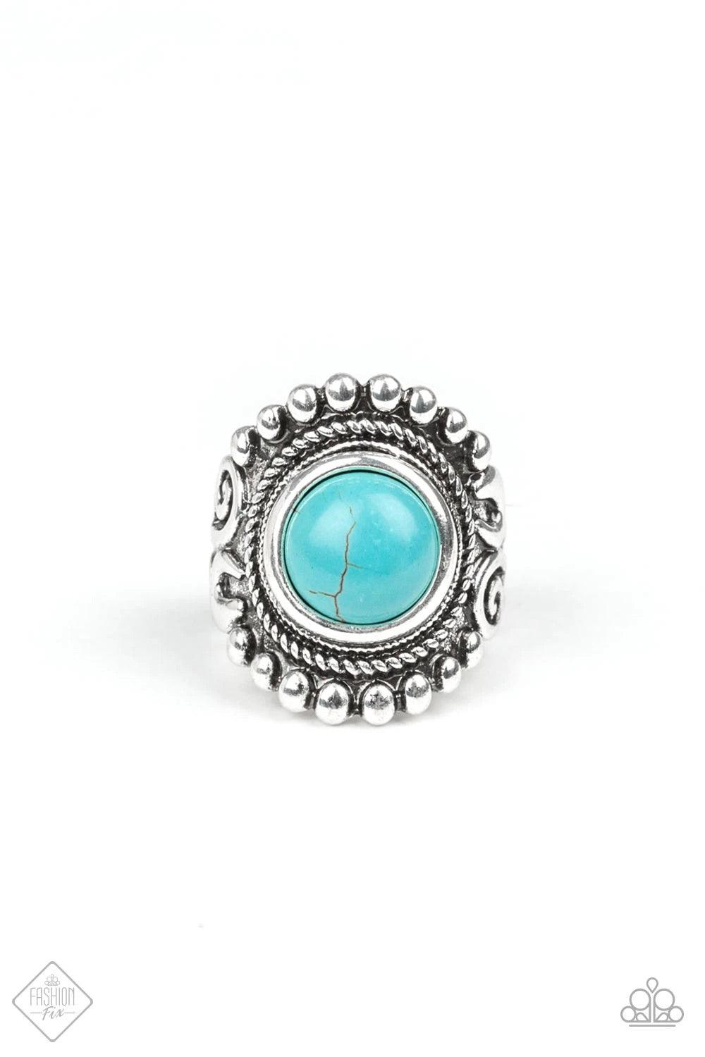 Paparazzi Accessories Normad Drama - Blue A refreshing turquoise stone is pressed into the center of a round silver frame bordered by shiny silver studs for a rustic look. Features a stretchy band for a flexible fit. Sold as one individual ring. Jewelry