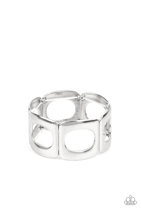 Paparazzi Accessories In OVAL Your Head - Silver Brushed in a gritty finish, airy ovals have been cut out of curved silver frames. Threaded along stretchy bands around the wrist, the airy frames allow the skin to peek through their centers for a natural f