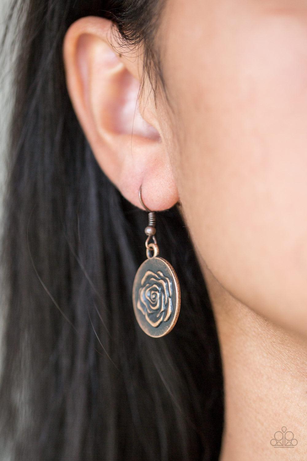 Paparazzi Accessories Beautifully Belle - Copper Embossed in a whimsical rosebud pattern, a shimmery copper frame swings below the collar for a casual look. Features a toggle closure. Sold as one individual necklace. Includes one pair of matching earrings