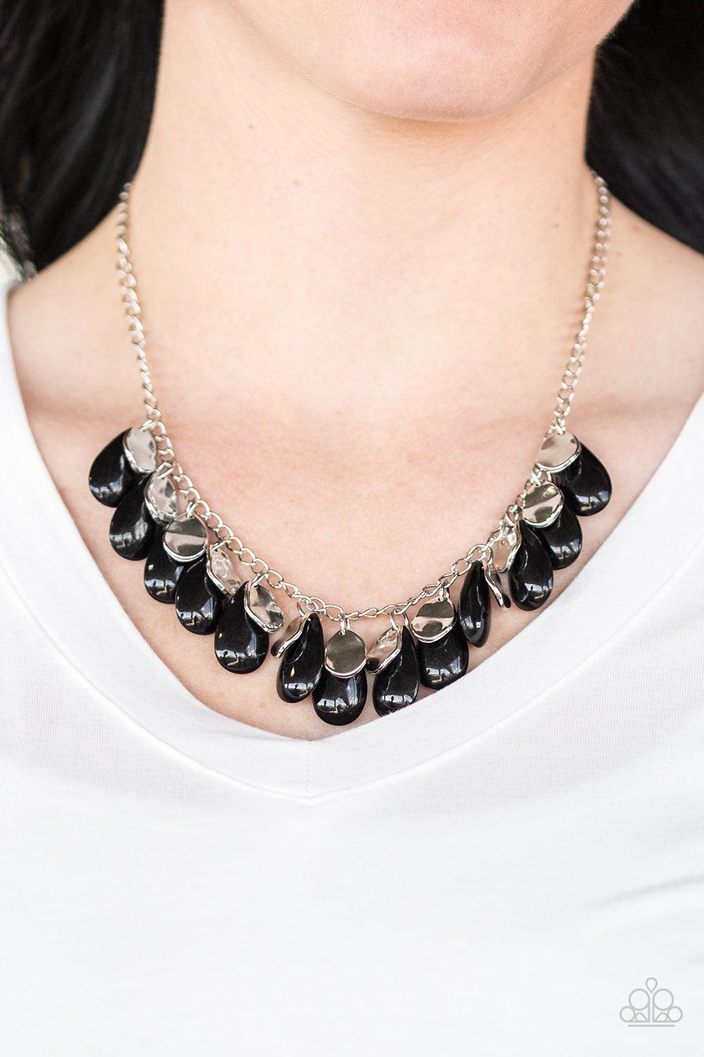Paparazzi Accessories Tropical Storm ~Black Polished black teardrops drip from the bottom of a shimmery silver chain, creating a colorful fringe below the collar. Featuring a delicately hammered surface, dainty silver teardrops are sprinkled along the cha