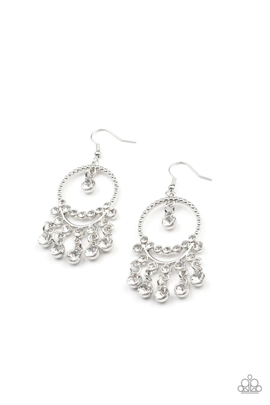 Paparazzi Accessories Cosmic Chandeliers - White Glassy white rhinestones swing from a row of glittery white rhinestones that attach to the bottom of a studded silver hoop. An additional row of blinding white rhinestones bows across the display, adding ex