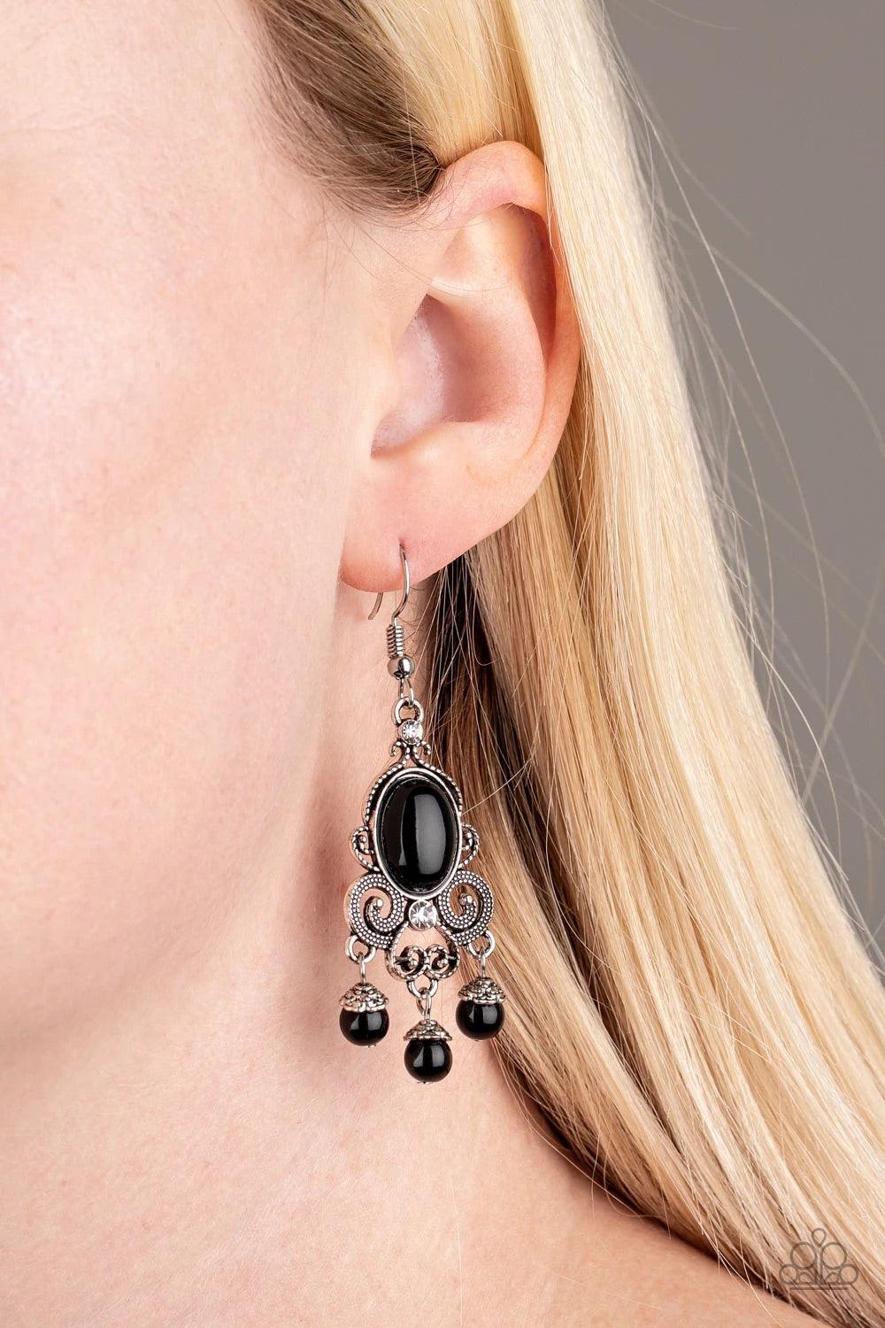 Paparazzi Accessories I Better Get GLOWING - Black Dotted silver filigree spins around a shiny black bead and dainty white rhinestones, coalescing into a regal frame. A beaded fringe swings from the bottom of the frame for a refined finish. Earring attach