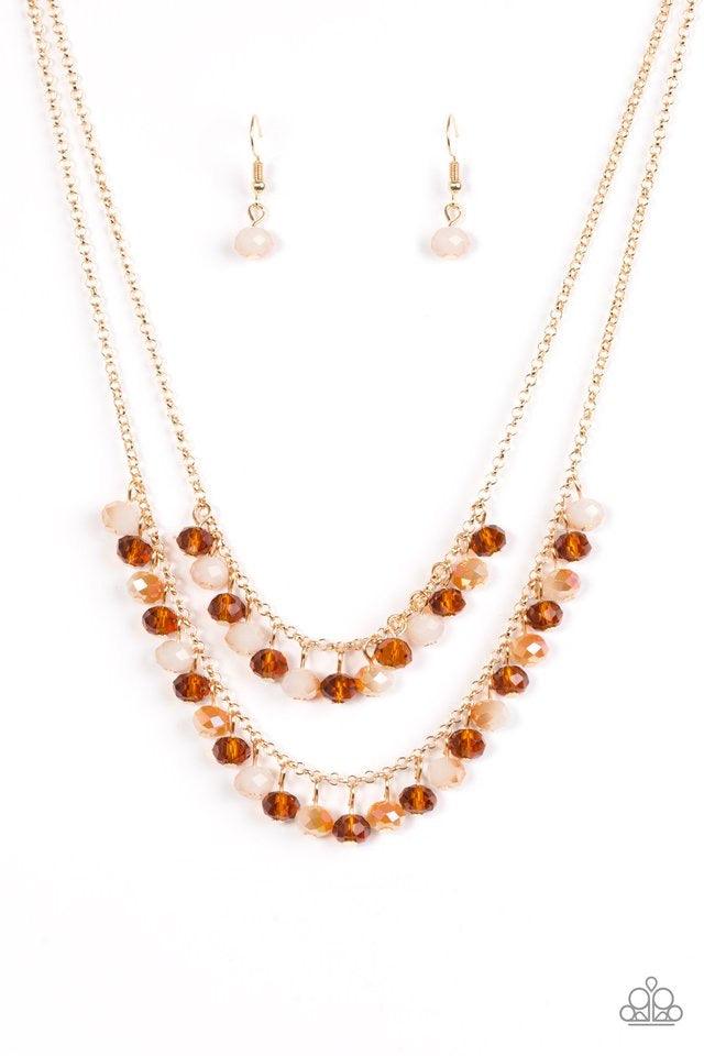 Paparazzi Accessories Starlight Sailing - Gold Brushed in an iridescent sheen, faceted white and brown crystal-like beads swing from the bottom of layered gold chains, creating a bold fringe below the collar. Features an adjustable clasp closure. Sold as