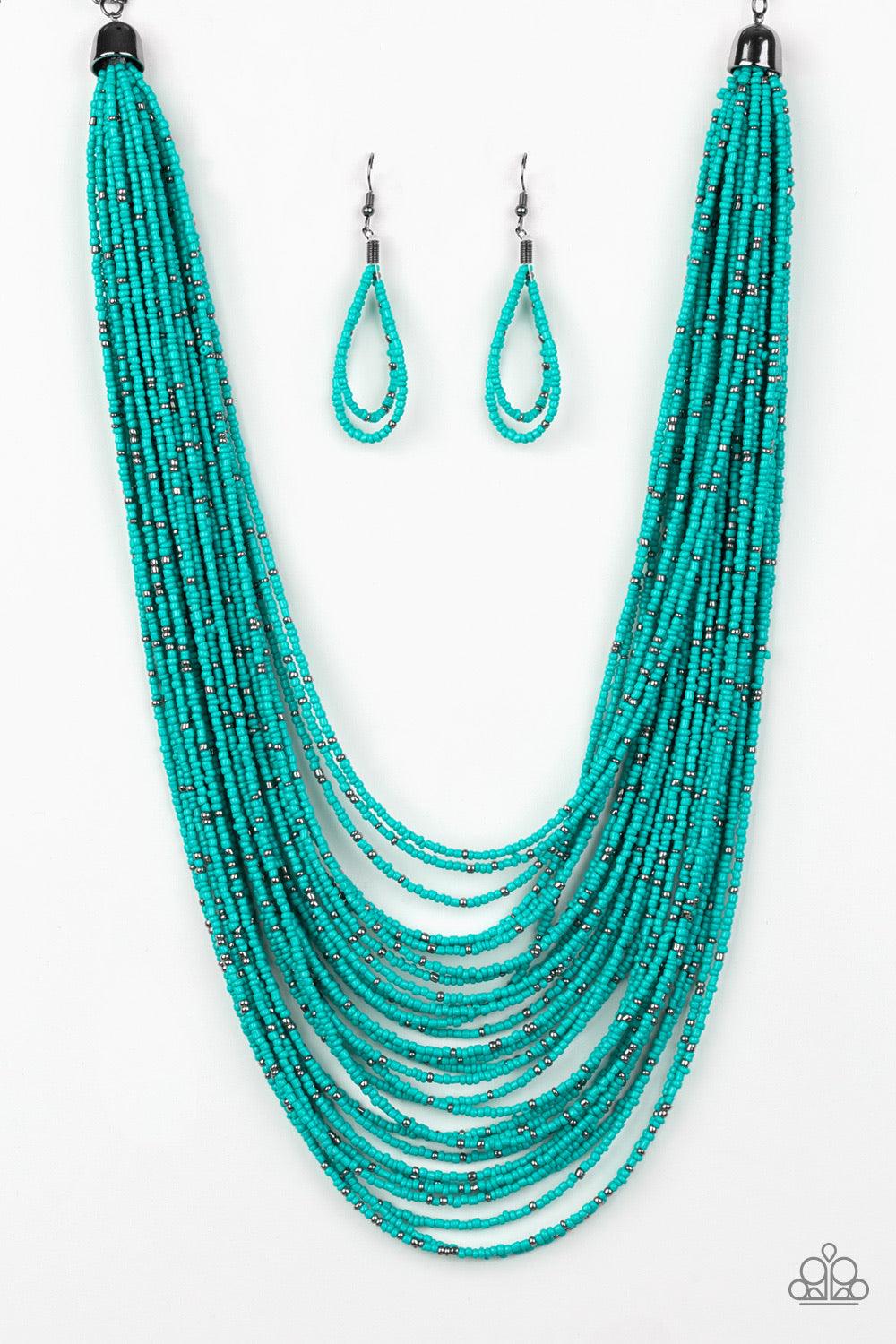 Paparazzi Accessories Rio Rainforest - Blue Suspended between two gunmetal fittings, row after row of countless strands of turquoise seed beads layer below the collar. Dainty gunmetal seed beads are sprinkled across the strands for a seasonal finish. Feat