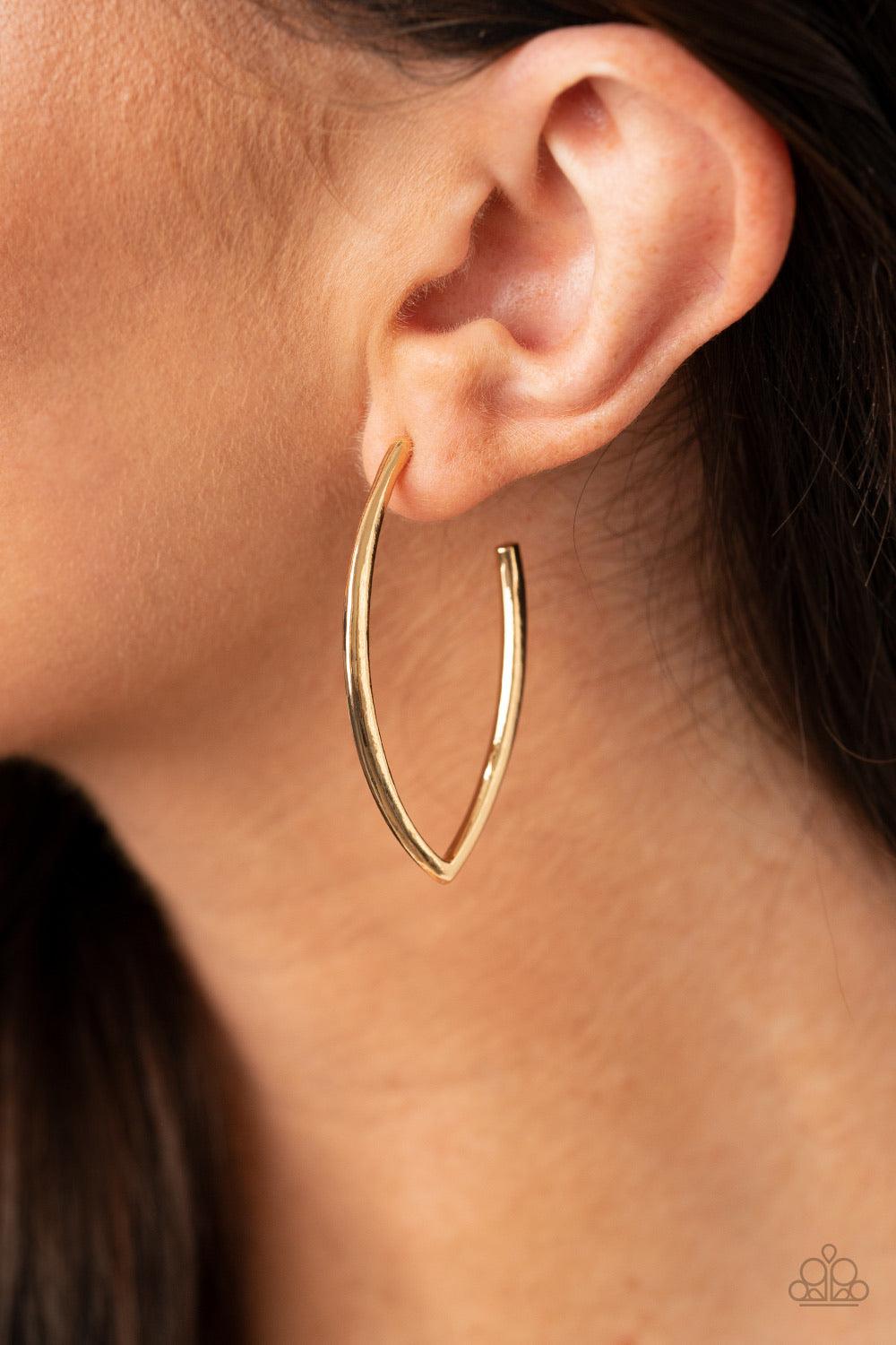 Paparazzi Accessories Point-Blank Beautiful - Gold A glistening gold bar sharply curves into an abstract hoop for an edgy finish. Earring attaches to a standard post fitting. Hoop measures approximately 1" in diameter. Sold as one pair of hoop earrings. J