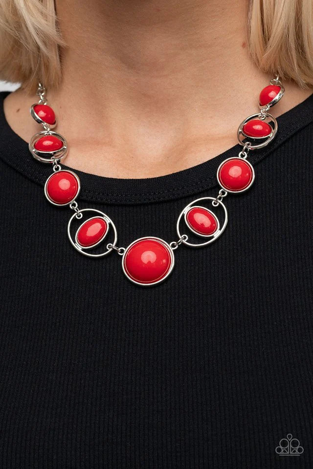 Paparazzi Accessories Eye of the BEAD-holder - Red Encased in sleek silver frames, a bubbly collection of oversized red beads alternate with oval red beaded hoops below the collar for a bodacious pop of color. Features an adjustable clasp closure. Necklac