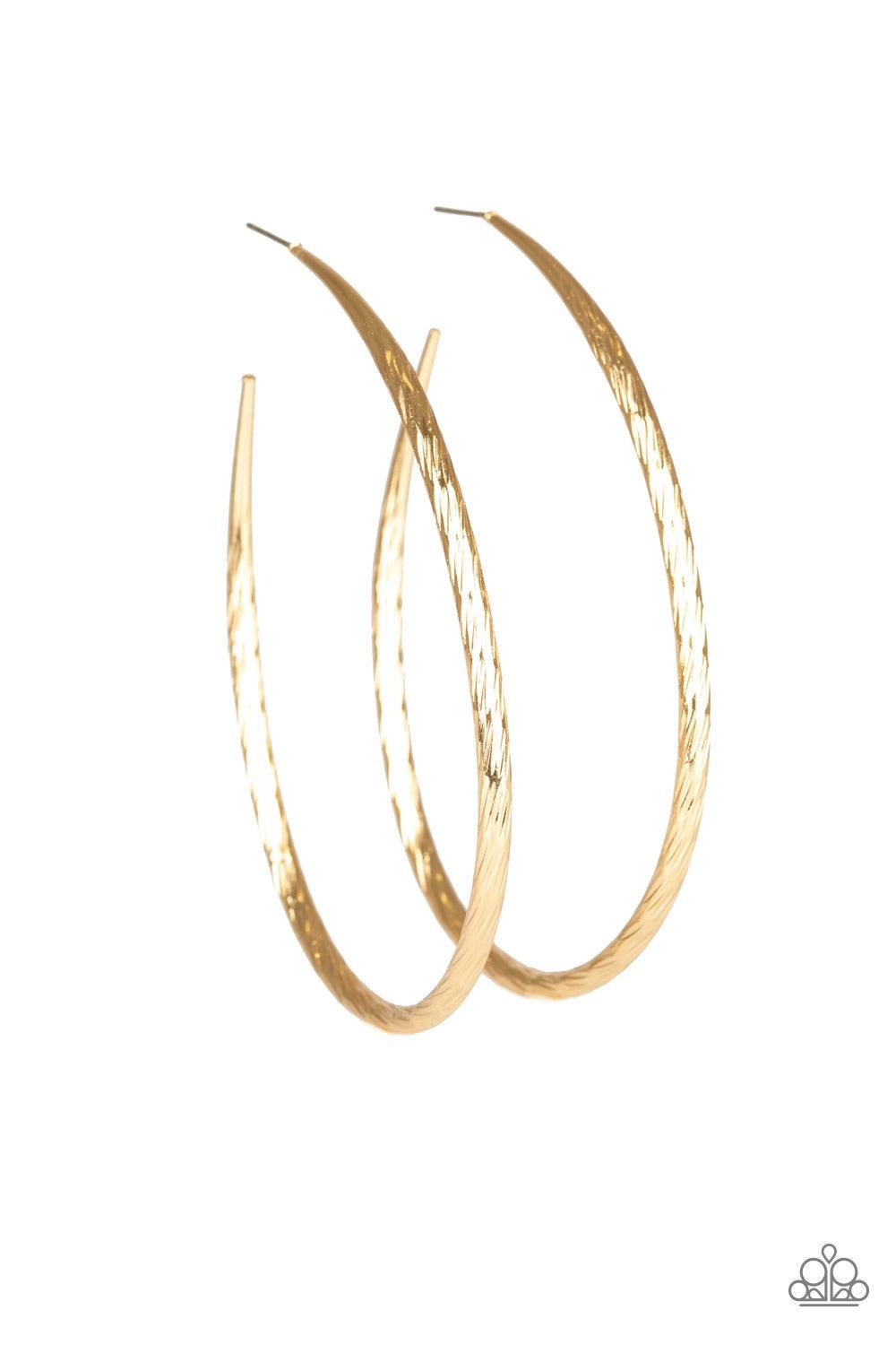 Paparazzi Accessories Fleek All Week - Gold Etched in shimmer, a rippling gold bar bends into a dramatic asymmetrical hoop for a showstopping look. Earring attaches to a standard post fitting. Hoop measures 3" in diameter. Jewelry