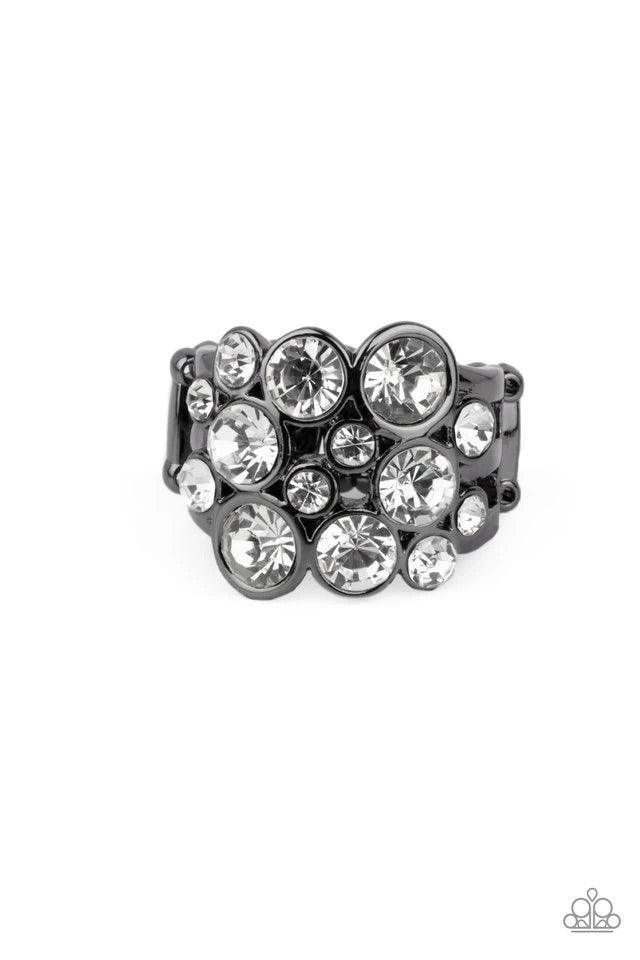 Paparazzi Accessories Bubbling Bravado - Black Encased in sleek gunmetal frames, a bubbly collection of sparkly white rhinestones coalesces into a glamorous band across the finger. Features a stretchy band for a flexible fit. Jewelry