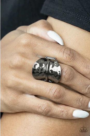 Paparazzi Accessories High Stakes Gleam - Black Featuring a high sheen, a hammered gunmetal disc, divided in half by a raised spine, floats up on each end for a gleaming high-stakes finish. Features a stretchy band for a flexible fit. Sold as one individu