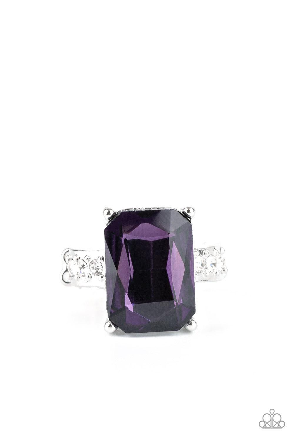 Paparazzi Accessories Bring Down the POWERHOUSE - Purple Featuring an elegant emerald-style cut, an oversized purple gem is pressed into the center of a dainty silver band dotted in glassy white rhinestones for a show-stopping sparkle. Features a dainty s
