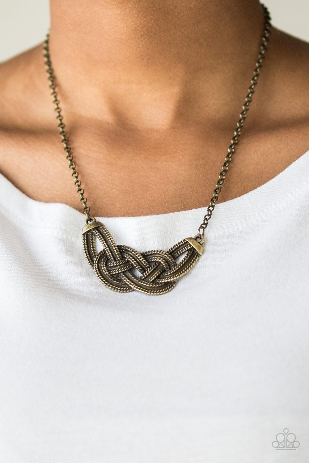 Paparazzi Accessories Nautically Naples - Brass Featuring chain-like patterns, antiqued brass bars knot below the collar for a bold industrial look. Features an adjustable clasp closure. Sold as one individual necklace. Includes one pair of matching earri