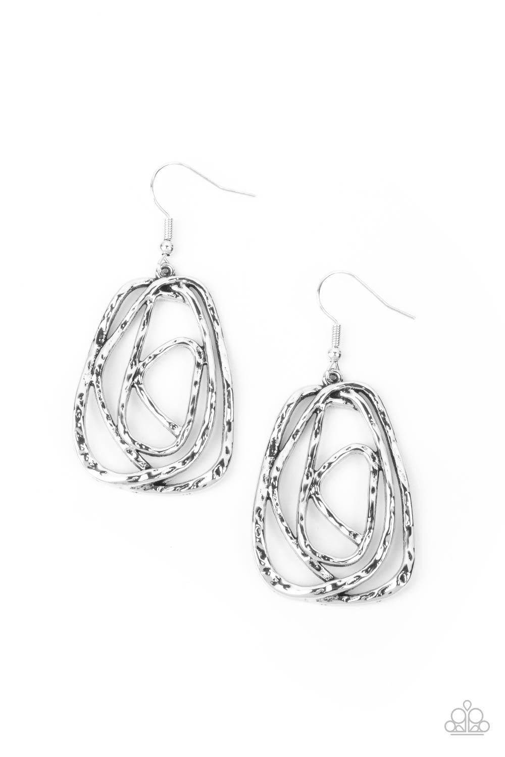 Paparazzi Accessories Artisan Relic - Silver Featuring a hammered finish, a rustic silver wire delicately wraps into an asymmetrical frame for a dizzying artisan inspired look. Earring attaches to a standard fishhook fitting. Sold as one pair of earrings.