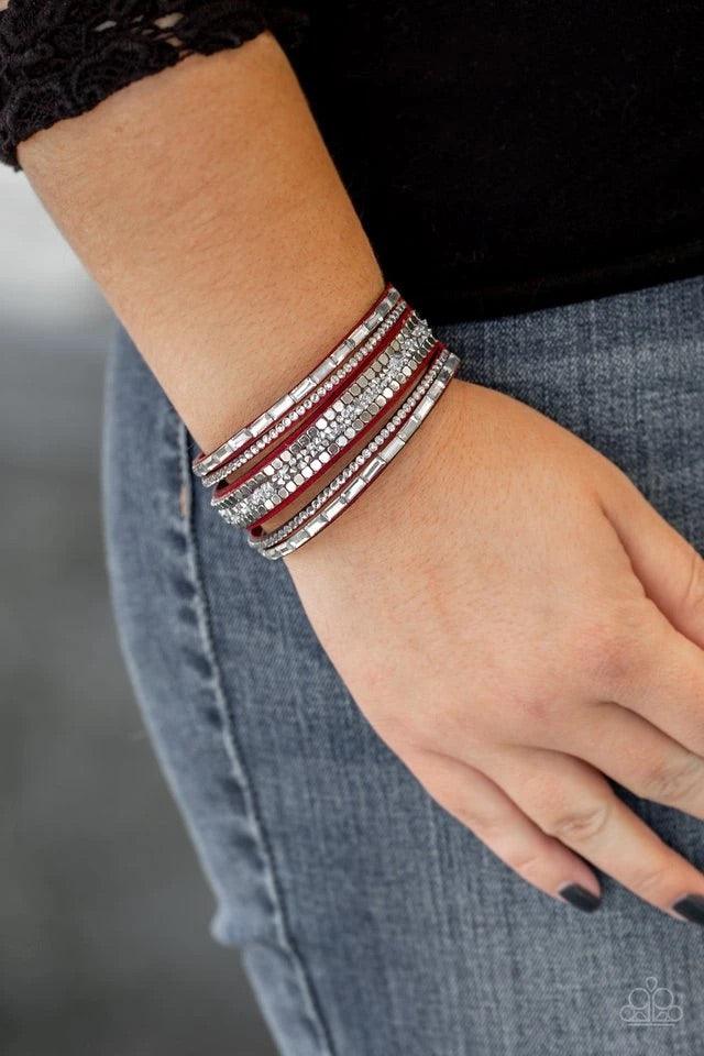 Paparazzi Accessories Rebel In Rhinestone - Red Featuring round and emerald style cuts, glassy white rhinestones join flat silver cubes and metallic prism rhinestones along a red suede band for a sassy look. Features an adjustable snap closure. Sold as on