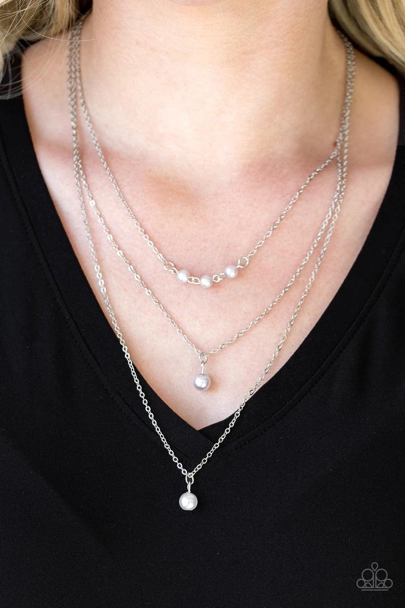 Paparazzi Accessories High Heels and Hustle - Silver A trio of pearly silver beads give way to layers of solitaire silver pearl pendants below the collar for a refined flair. Features an adjustable clasp closure. Jewelry