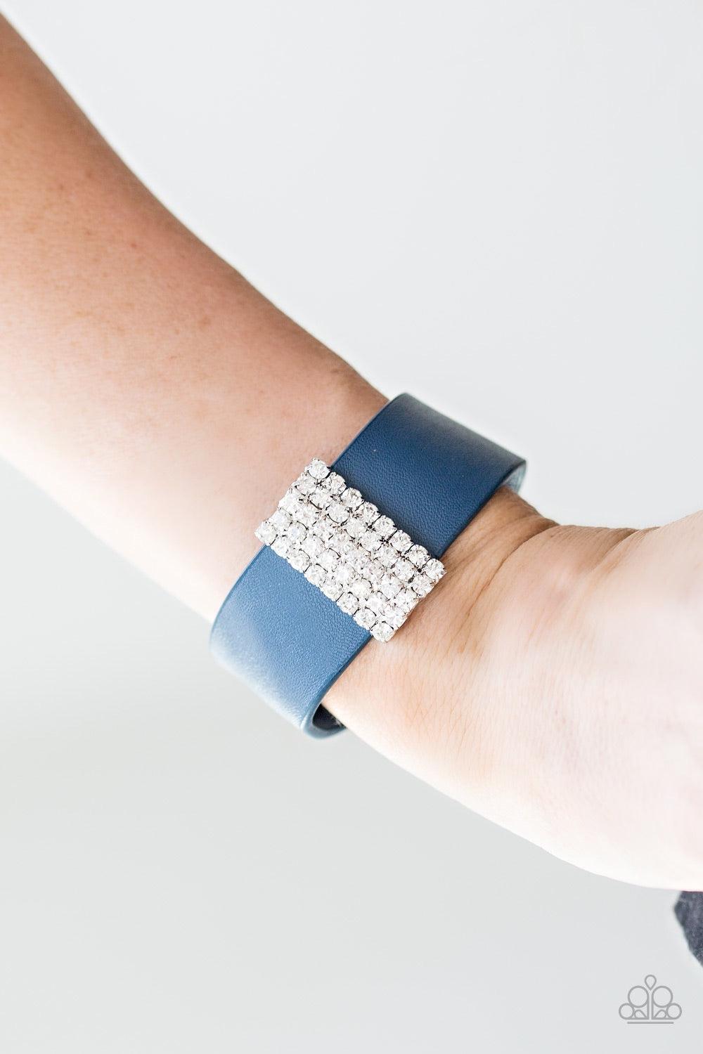 Paparazzi Accessories Walk The Catwalk - Blue Encrusted in glittery white rhinestones, a sparkling frame slides along a strip of blue leather, creating a blinding centerpiece. Features an adjustable snap closure. Jewelry